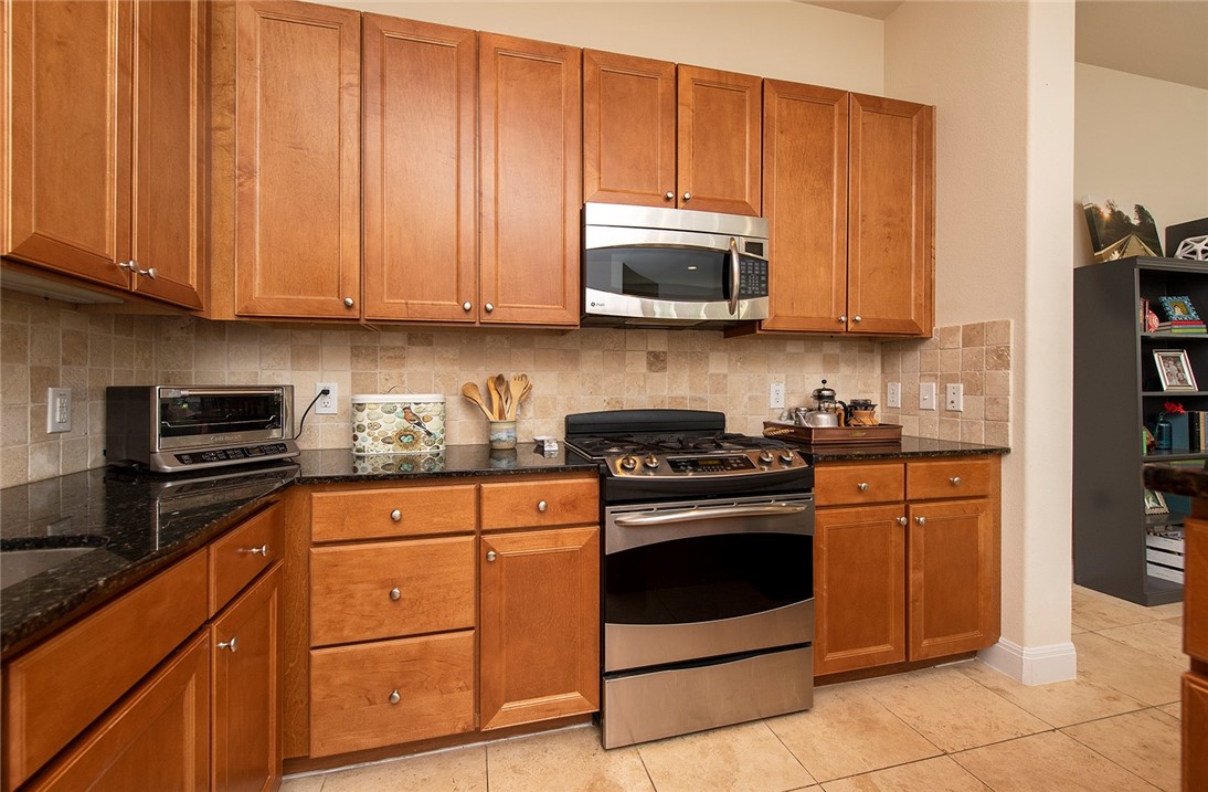 Photo #8 This kitchen has a generous amount of cabinets, including convenient pan drawers