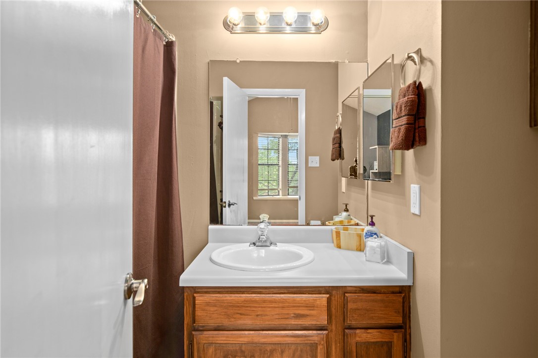 Photo #23 The second full bathroom offers a single vanity and a tub/shower combo.