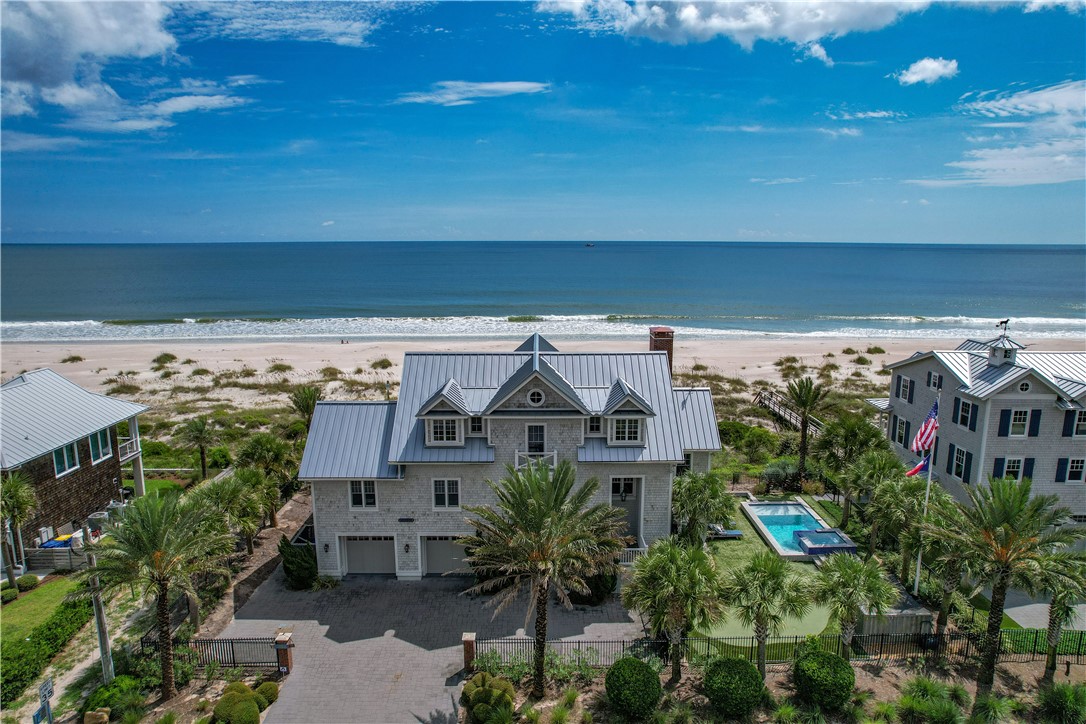 COASTAL LIVING dream home combining exquisite quality with sophisticated style. Constructed in 2015, this oceanfront 4BR/5.5BA (+ bunk room) haven feels like a dream everyday. Amenities include: THERMADOR appliances, GAS 6 burner range complimented with double ovens, built-in microwave/warming drawer, marble countertops, walk-in Butler's pantry, water softener, gas tankless water heater, impact windows, swanky laundry room with open shelving and extra storage, private writer's studio/library, & a 3 stop ELEVATOR. Poolside living space includes wet bar with beverage fridge & ice maker, BUILT-IN BUNK ROOM + full bathroom. Your outdoor OASIS boasts a heated private pool/spa, 5 hole hole putting green, cozy fireplace, double decker porches with IPÉ decking, PRIVATE beach walkover and Nantucket-style cedar shake exterior. Paradise found! Love where you live.