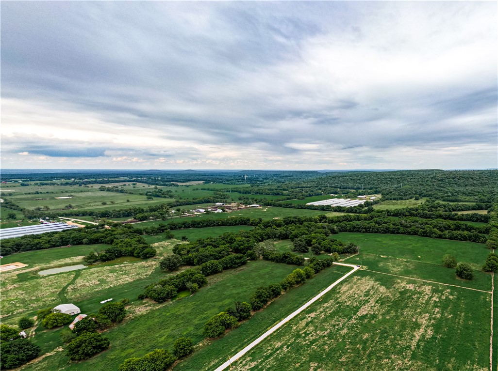 Beautiful acreage ready to build! Pasture, level field, mature trees, paved road, and thriving wildlife. Property is fenced and cross fenced - Pipe fencing completed in 2022, electric on site, scenic views. Great location near the bike trail access and close to public hunting land.