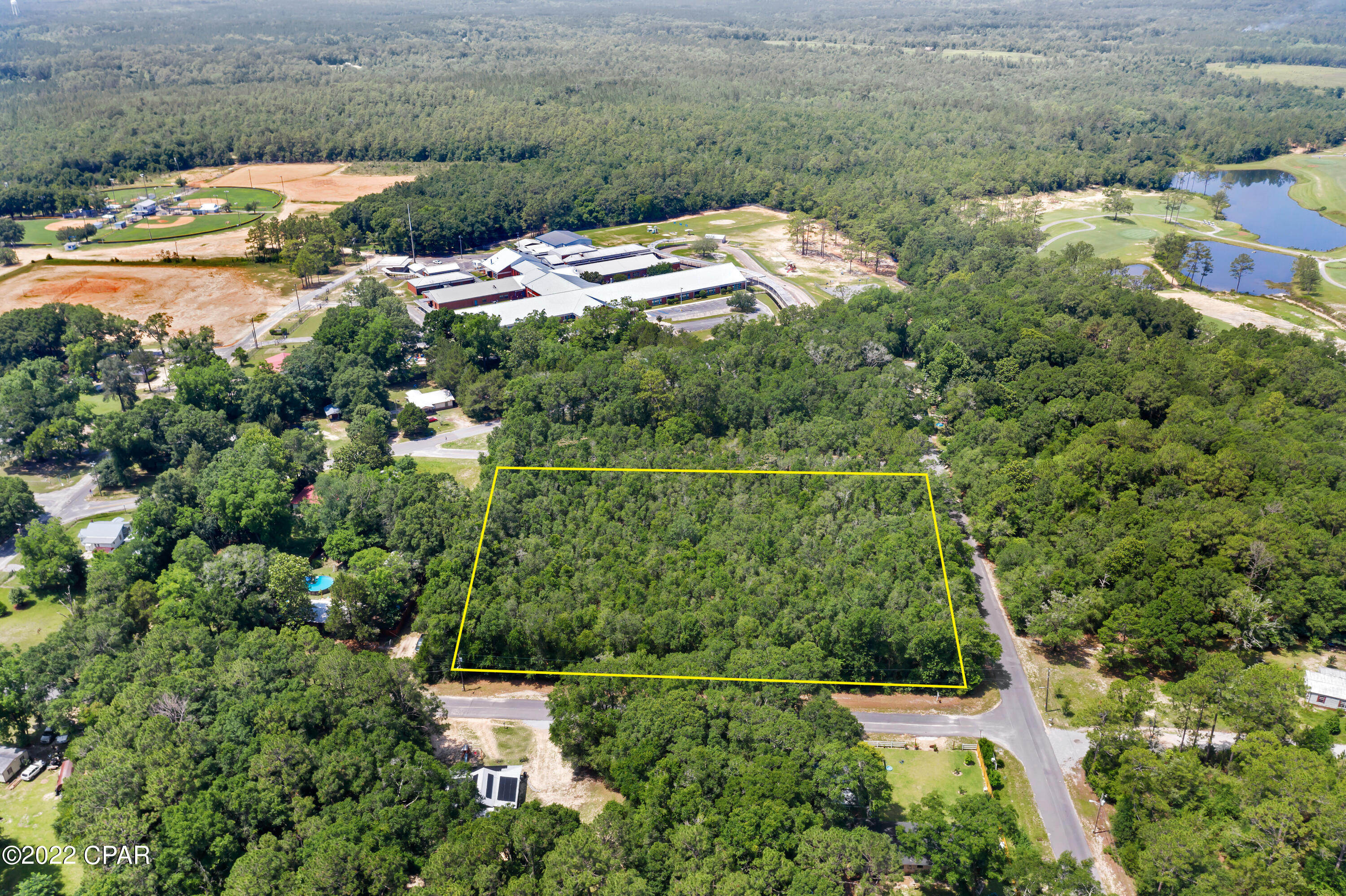 BRING OFFERS! Large wooded lot within the city limits of Defuniak Springs and within walking distance to West Defuniak Elementary school as well as shops and stores. Paved road frontage on three sides with frontage on Love Ave, S 26th Street, and Van Buren Ave. Would make a great place for an investor to build several starter homes.