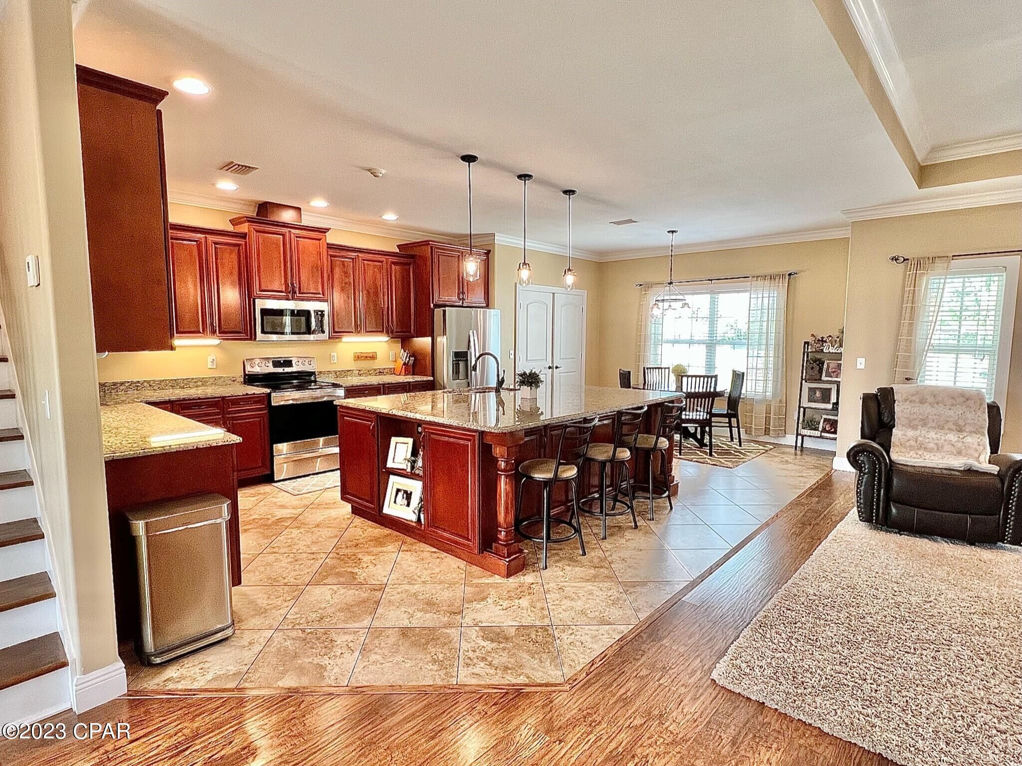 Beautiful custom-built brick home on approximately 9 acres! It has everything you need and is located perfectly between Grand Ridge and Sneads with over 800 ft of Highway 90 road frontage. It is 3 bedrooms, 2.5 bath, with a home office and large finished out bonus room upstairs that is 15x28. The home features a large open floor plan with 9 ft ceilings throughout! The kitchen has a huge island for cooking and family gatherings, very nice all wood cabinets with granite counter tops in the kitchen and all bathrooms! There is a 2-sided stone gas fireplace and also has gas hookup on the back porch for your grill. All stainless-steel appliances in the kitchen are included! Crown molding is throughout most of the home.