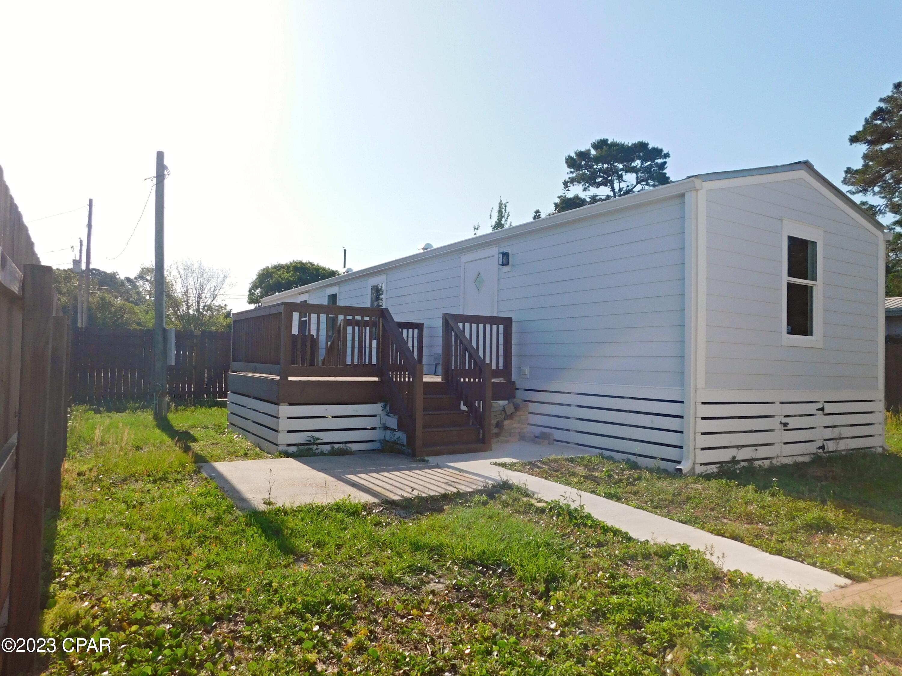 Beautiful mobile home conveniently located in Panama City Beach near Pier Park, restaurants, malls and endless entertainment for the whole family. Only a few blocks away from the beach!.LVP Flooring throughout the interior of the property, freshly painted, very spacious front and fenced backyard with a room for a pool, includes a storage shed, washer and dryer. Take a look at this property it won't last long!