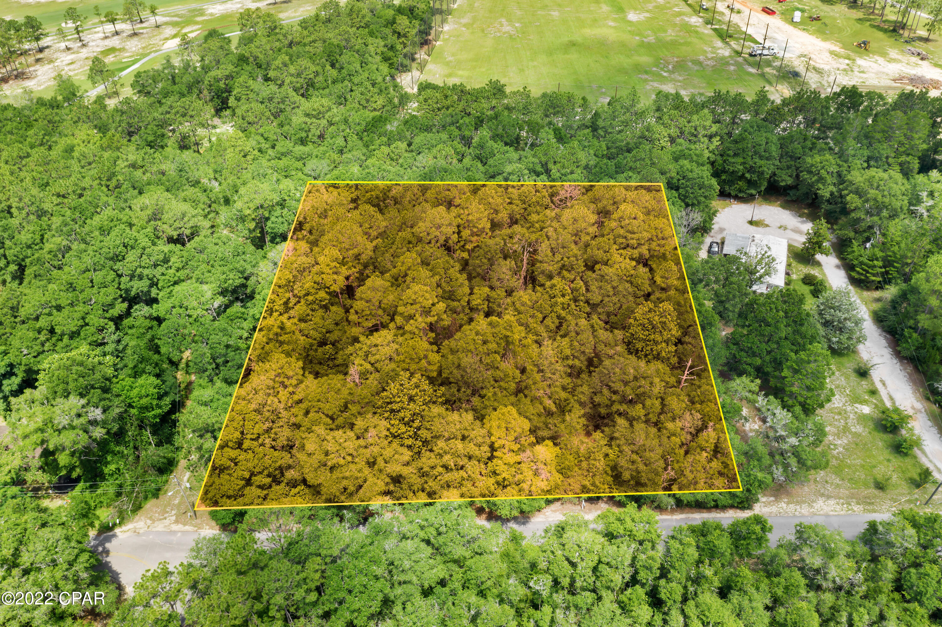 BRING OFFERS! Nice wooded lot on a paved road within the city limits of Defuniak Springs, adjacent to Walton County Country Club with golf course frontage and within walking distance to West Defuniak Elementary School. Would be a great place for a developer to purchase to build townhomes or homes along the golf course.