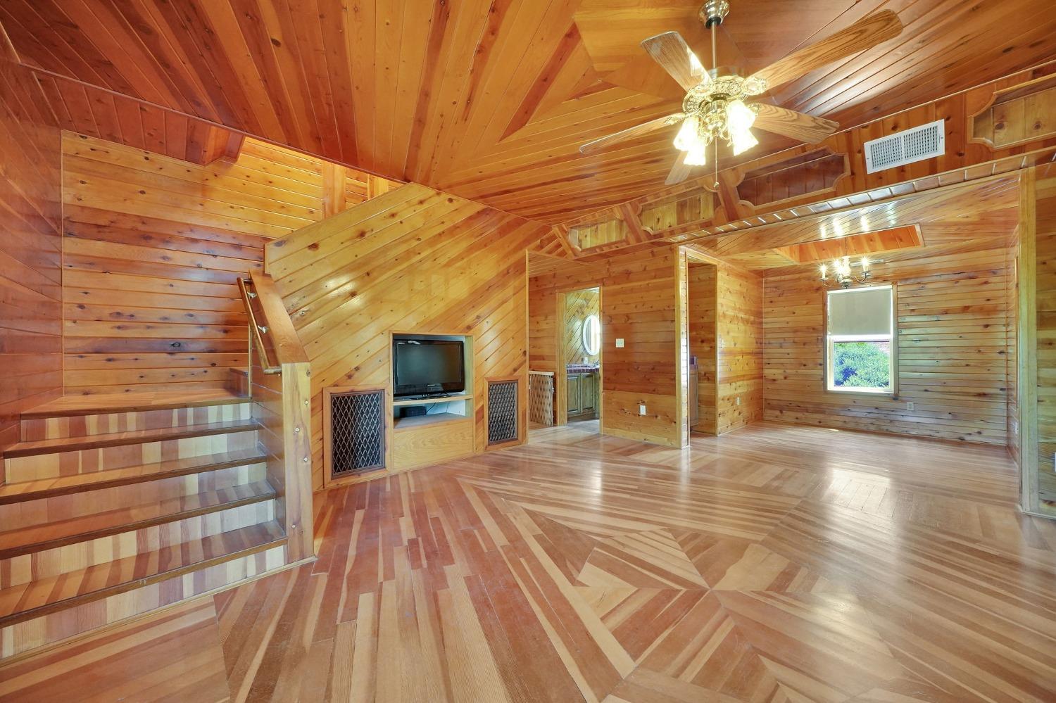 Living room with built in TV area and staircase to the upstairs