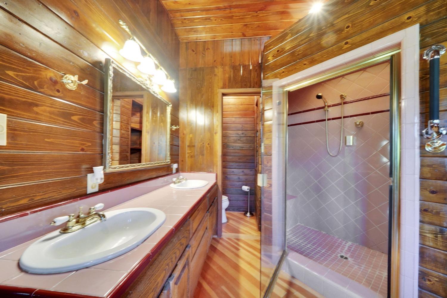 Primary bathroom features a claw foot tub, steam shower, double sinks and a toilet closet