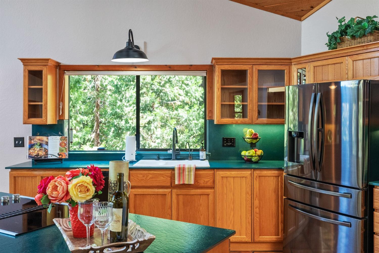 Kitchen features custom lighting, cabinetry and instant hot water.