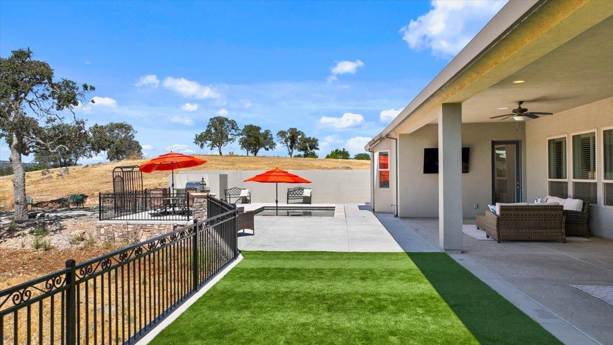 Large covered patio overlooking the fairway includes Pebble Tec pool with Baja shelf, plenty of seating and outdoor TV