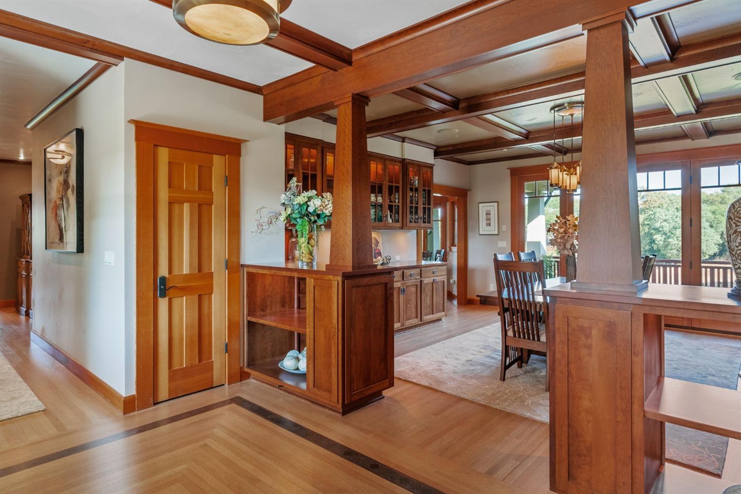 Formal Dining with coffered ceiling and 8' long built in buffet and glass front