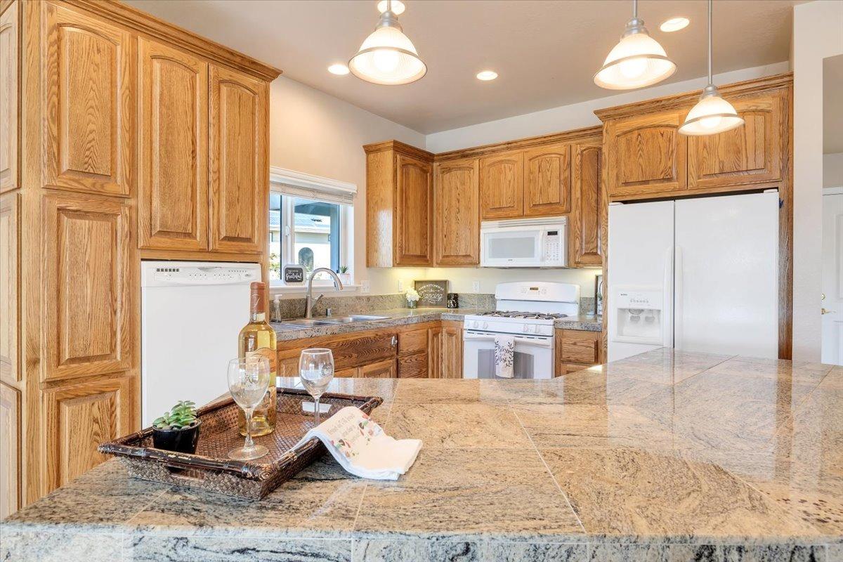 Gleaming granite-tiled countertops and large island bar.