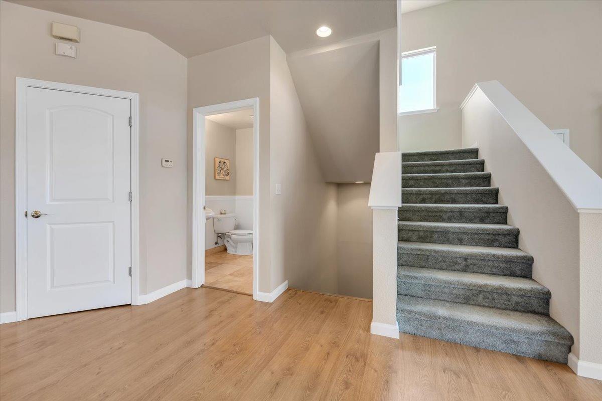 Stairway heads down to the primary suite or up to the loft and guest bedroom quarters.