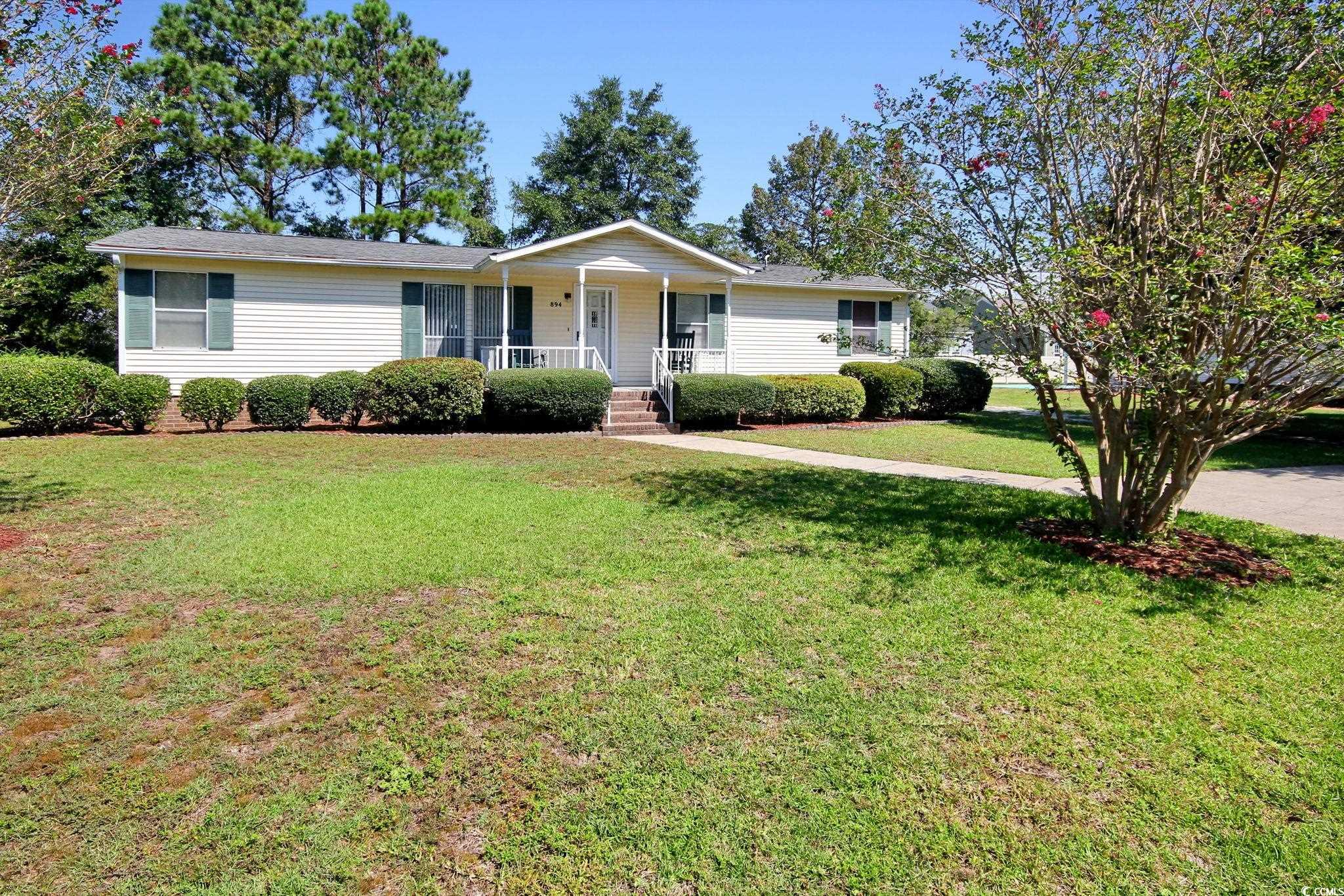 this charming mobile home with a cozy front porch rests on a spacious lot in the live oak community. upon entering, you will appreciate the chair railing and natural lighting that beautifully adorns the sitting room. your kitchen boasting ample storage guides you to the lovely dining area perfect for meals with the ones you love. you also will enjoy relaxing in the living room with direct access to the spacious sunroom. the master bedroom features a walk-in closet and a private ensuite. the 2 additional bedrooms share access to a full hall bath. out back, you have access to a covered porch area and an outbuilding for storage. the live oak community provides you with access to a clubhouse and sparkling neighborhood pool. you are also so close to shopping, dining, the local recycling center, and hospital. the beach is also only 10 minutes away!! come see your new home today!