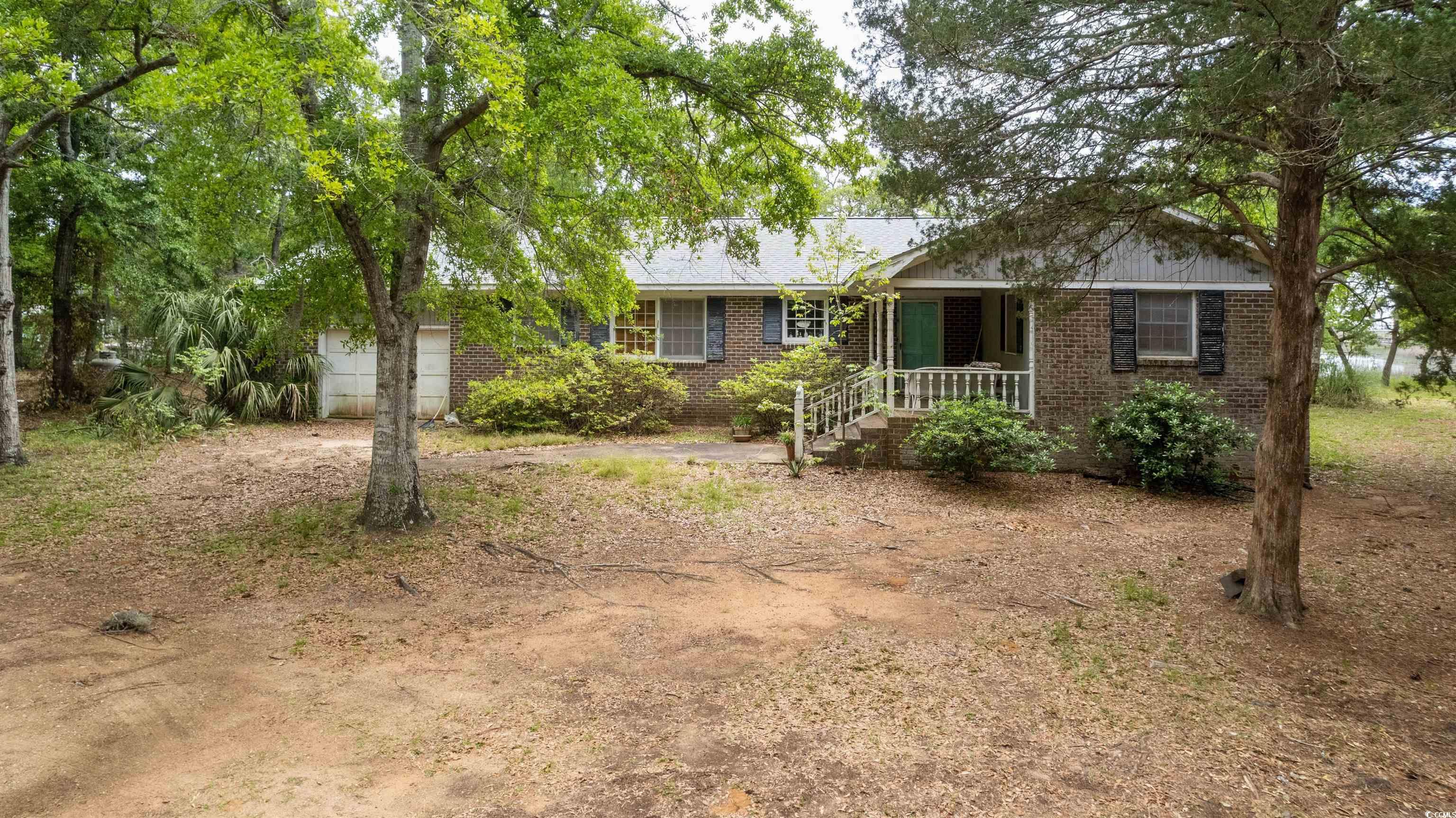 location, location, location! if a private island like setting on the beautiful murrells inlet creek intrigues you then this is it!  endless creek views, mature trees and access to all murrells inlet has to offer via a short boat ride! the two bedroom brick ranch home can be renovated to meet your desires or you can build your dream home on this estate sized lot.  you must see this to believe the setting of this beautiful property yourself!
