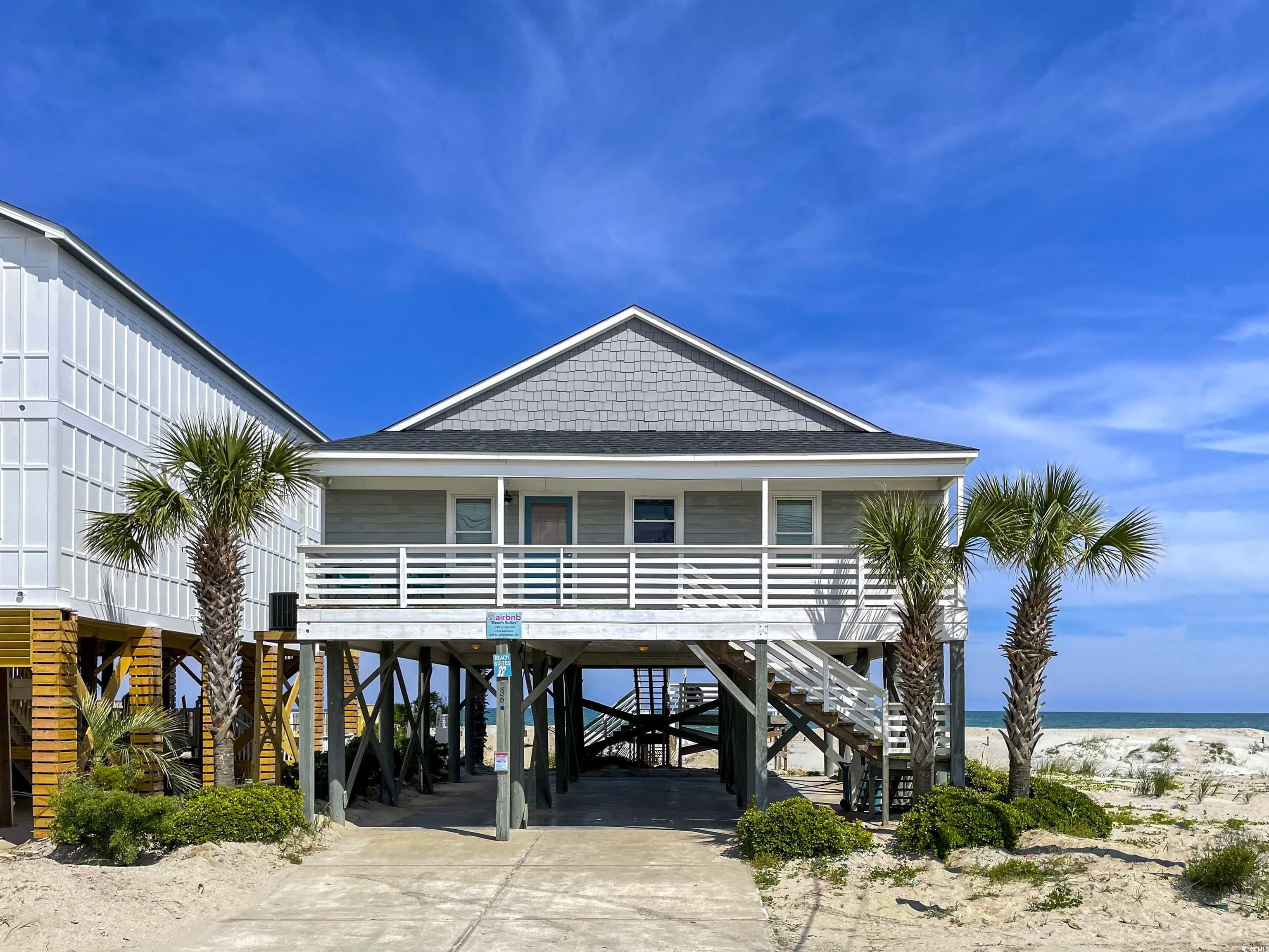 relaxing oceanfront year round beach cottage, nestled between the garden city pier and inlet harbor. imagine walking minutes to garden city pier, arcade, ice cream and restaurants! walk out your backdoor and relax on your deck area with an oceanfront view or walk down your private pathway to put your toes in the sand. live the vacation lifestyle in this open floor plan, 4 bedroom, 4 bathroom home. two of the bedroom en-suites are direct oceanfront view. all 4 bedrooms boast a king bed, with the master also having a twin daybed. family room is open and airy with a cathedral ceiling and spacious for entertaining easily between kitchen and family area. a sofa in the family room also has has a sofa bed.  the home is being sold completely furnished. great opportunity for a second home, investment, short term rentals allowed. new hvac system installed in 2022.