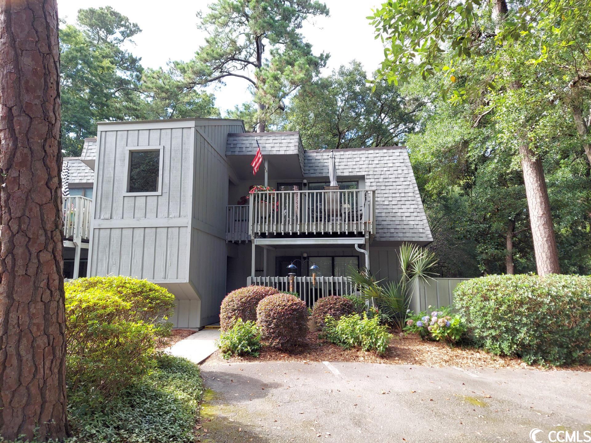 this litchfield condo is very stylish and perfect for a vacation home or full time living on the coast. beautifully furnished and move-in ready! featuring two bedrooms, two full baths, and updates throughout including white granite and white cabinets in kitchen and bathrooms, neutral walls and tile flooring. renovated kitchen is is open to the dining area and family room. the kitchen features stainless appliances, tile backsplash, white granite counter tops, and a counter height breakfast bar with lots of storage cabinets underneath. this condo is an end unit and has long windows in all rooms, including an extra window in the family room, with views of live oaks and azaleas galore in the springtime. there is an oversized deck (11'x11') with large table and umbrella where you can enjoy meals with views of the trees and palms.  the master bedroom has a queen bed and a single bed, walk-in closet, linen closet and ensuite bath with white granite countertop vanity and a tub/shower combination.  the guest bedroom has a single bed and a bunk bed with single over double bed. the hall bathroom has white granite countertop vanity and a tub shower combination.  this condo is furnished to sleep 7.  salt marsh cove is located on the creek and has a community crab dock with gorgeous views of the saltwater creek and marsh. there is a community pool, clubhouse with decking and lake view, and small boat storage is available. enjoy coastal life - the natural beauty of the creek, and it is just a short 5 minute drive to the beach.