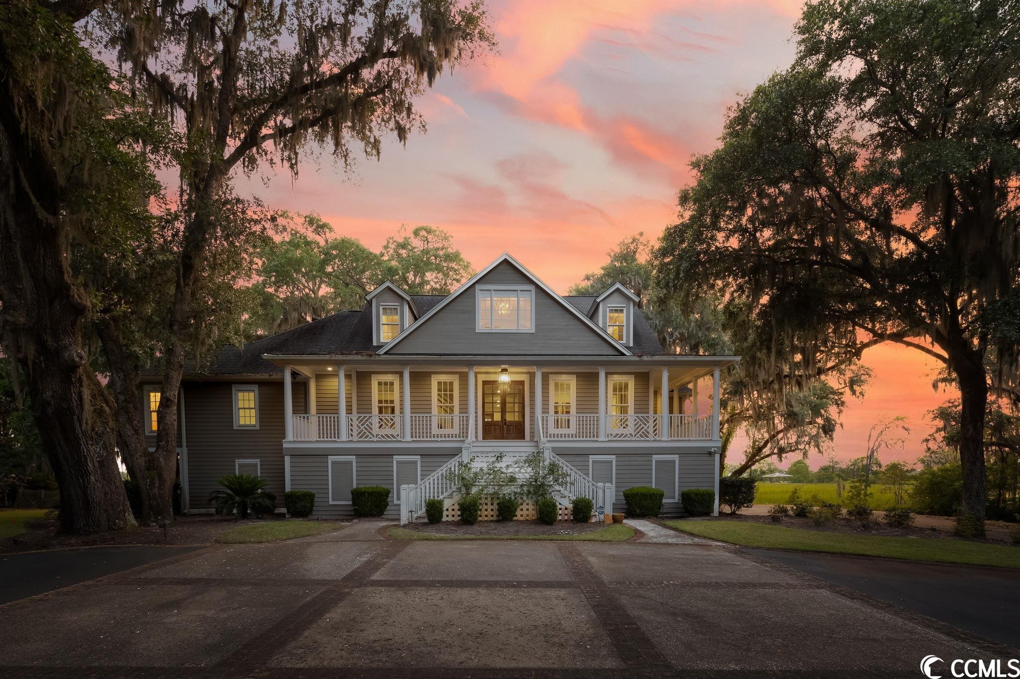 incredible southern low country home in pawleys island offering breathtaking sunsets and a charming ambiance! as you approach the property, you are greeted by a picturesque driveway lined with classic live oak trees adorned in spanish moss. the grandeur continues with a large wrap-around front porch that invites you to the double front doors. stepping into the foyer, your eyes are immediately drawn to the magnificent view of the beautiful waccamaw river. to the right, you'll find a well-lit home office, providing an ideal workspace. straight ahead from the foyer is the spacious living room, featuring a fascinating custom oyster shell fireplace as its centerpiece. through the large paned glass doors from the living room, you enter the carolina room. this room is adorned with heartwood pine on the ceiling and floor-to-ceiling windows, offering yet another opportunity to revel in the stunning views. the carolina room is spacious enough to accommodate a dining table, providing a perfect setting for meals. throughout the main level, you'll find heartwood pine flooring, enhancing the home's charm and warmth. connected to the carolina room is a roomy screened porch, allowing you to enjoy the outdoors comfortably. the chef's kitchen is a culinary enthusiast's dream, equipped with double ovens, a wolf cooktop with a vented hood, a subzero refrigerator, two sinks, two dishwashers, stainless steel appliances, granite and stainless-steel countertops. the kitchen also boasts beautiful custom cabinets, featuring a built-in glass china closet and built-in shelving. a work island with a sink and breakfast bar adds further functionality to the space. the spacious master bedroom serves as a peaceful hideaway, offering ample room for a cozy sitting area. it includes a custom walk-in closet and french doors that open to a private screened porch, providing yet another tranquil retreat. the master bathroom is nothing short of a dream, featuring a soaking tub, a custom tiled walk-in shower with multiple shower heads, and separate his and her vanity areas with water closets. moving upstairs, you'll discover three bedrooms, two bathrooms, and a bonus room area that can serve as a craft room or playroom, catering to your specific needs. on the bottom level, there is a full (mother-in-law) apartment, completely updated and equipped with a full kitchen, living room, bedroom, laundry, and bathroom. additionally, downstairs features a separate and private home office with stunning views of the waterway. extra amenities include an elevator for convenient access to all levels, automatic roll-up screens on sunroom windows, an outdoor firepit, and a private creek dock leading to the river. for a comprehensive overview of all the upgrades, please consult your agent.