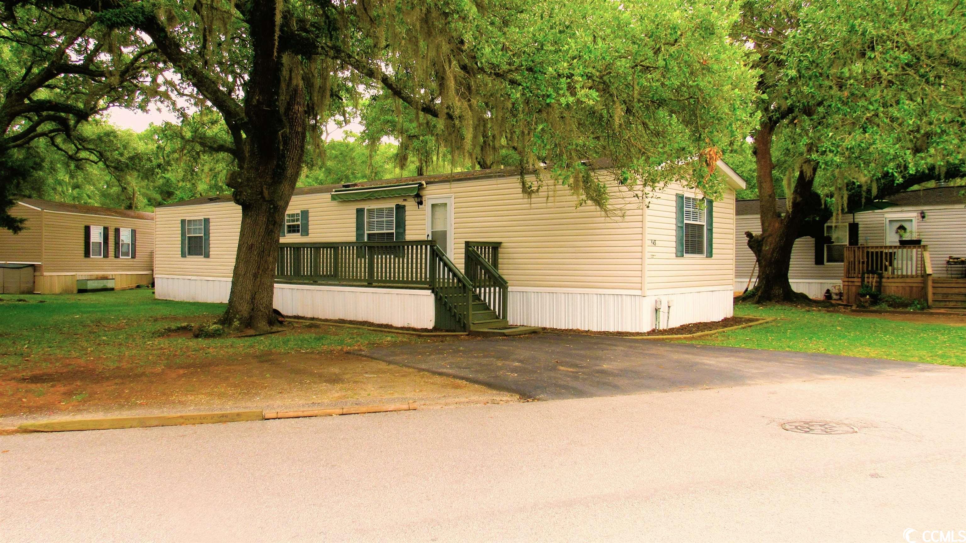 charming 2 bedroom, 2 bath home in the quiet community of key largo. featuring a split bedroom floor plan, this home has been freshly painted throughout, has new stainless steel appliances, new light fixtures and ceiling fans. the laminate flooring is not only resilient but easy to maintain. in the spacious kitchen you will find plenty of cabinetry, a separate laundry room complete with washer/dryer, additional storage space for pantry items  and room for a dining table. just down the hall from the kitchen is the large private master bedroom with its own bathroom and walk-in closet. the second bedroom is on the other side of the home along with the additional full bathroom. outside is new vinyl underpinning and freshly mulched flower beds – ready for new plantings. the large front deck with an awning has been newly stained and is the perfect spot to unwind and relax or enjoy a cup of coffee to start your day. located in the heart of murrells inlet you are just a short ride to the marsh walk, marinas, entertainment, night life and some of the best restaurants around! this home is a must see! (home is on leased land – lot lease includes water and sewer.)
