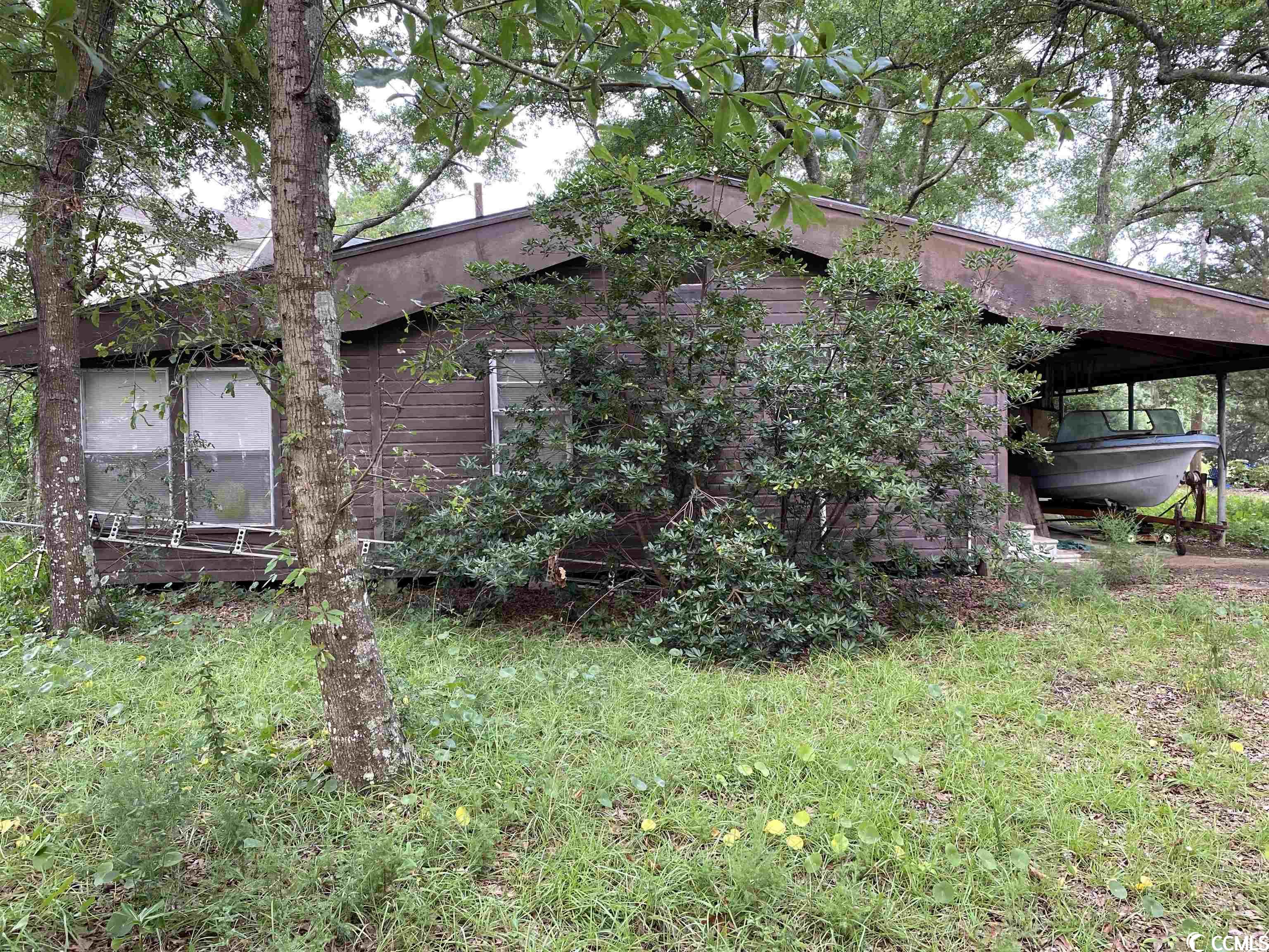 this is a wonderful lot approximately 1/3 of an acre on the creek with beautiful views of the inlet.  there is a small drive lowering into the creek which is tidal and allows access at high tide. great lot in a quiet subdivision close to the water, restaurants, shopping, and all that the coast and murrells inlet have to offer.  many trees on the property offering shade and respite from the summer sun and heat. the home/structure on the property is not habitable and seller assigns no value to the structure.  seller will remove two boats and trailers from the property before closing.
