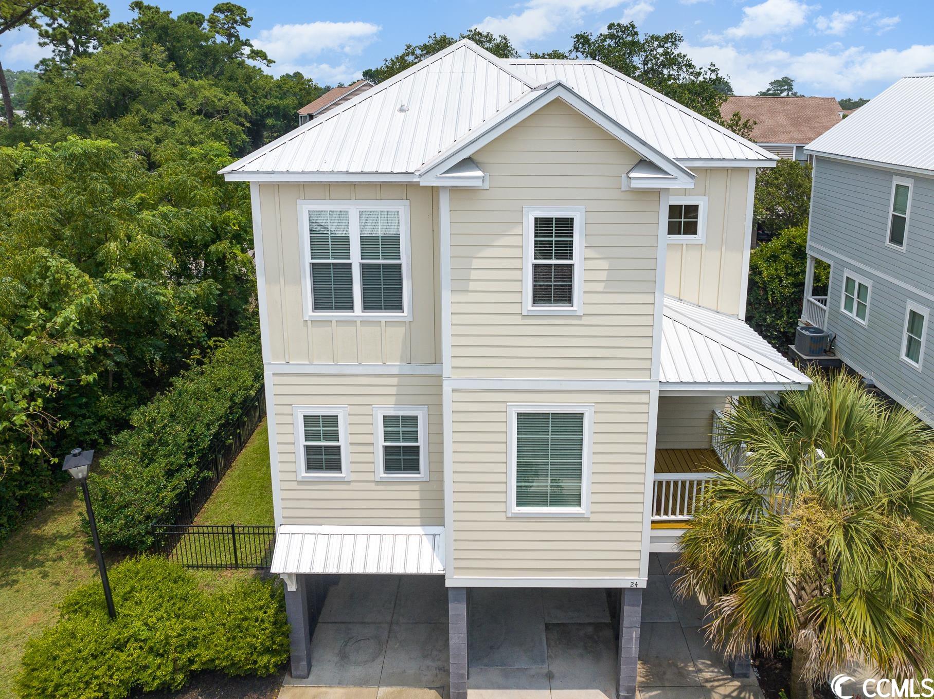 nestled in the tranquil and picturesque litchfield marsh community, this splendid 3-bedroom, 2.5-bathroom raised beach home is a testament to craftsmanship and aesthetic charm. showcasing one of the largest floor plans within the neighborhood, this house embodies the essence of gracious living.   beyond its impressive layout, discover an array of high-quality upgrades. custom cabinets, granite countertops, and stainless steel appliances accent the kitchen, while a large walk-in pantry offers ample storage. the master suite invites relaxation with a generous walk-in closet and private deck.   practical features include a large laundry room, workshop, under-house boat storage, and sprinkler system. the exterior boasts hardiplank siding and a metal roof, complemented by a landscaped fenced yard and two outdoor spaces. enjoy the luxury of vinyl tile flooring, elegant bathroom tiling, an instant hot water system, solar porch shades, and a pre-built elevator shaft for future accessibility. just minutes away, east of highway 17, lies huntington statw park, the beach, and a variety of shopping and dining options. experience the unique charm of this custom home by booking your showing today.