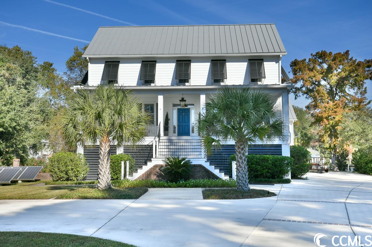 exceptional low country raised farm house on a canal in the much sought-after, beautiful neighborhood of waverly mills in historic pawleys island, sc.  this 5 bedroom, 5.5 bath home was built in 2003 and completely renovated in 2021.   welcome home to 125 angel oak drive.  you enter from the substantial front porch to the wide central hall flanked by an inviting living room and home office to your left.  your right is the impeccable formal dining room.  each room has a fireplace with lovely built-in book cases and glass paned pocket doors.    the spacious cooks kitchen features all stainless appliances including a 6 burner gas range, built in wall oven and microwave, and sub zero refrigerator.  the generous island is full of storage and has a built-in ice maker for all your entertaining needs.  the kitchen and formal dining rooms are connected by a beautiful butlers pantry loaded with storage.  there is also a kitchen utility room with sink and room for your extra refrigerator which makes serving large dinner parties a breeze.  the kitchen and main family living area are all open and inviting.  gather around the fireplace or enjoy a cocktail on the large wrap around porch overlooking the dock with boat lift on waverly creek that will take you directly out to the waccamaw river.  this is a 16,000 lb lift equipped to handle up to a 30ft center console boat.   the owner's suite is a dream come true with his and hers custom closets, large private bath including a dynamic far infrared sauna, and separate laundry room.  make your way up the extra wide stairway or take the elevator to the third floor to find a charming sitting area between two identical en-suite bedrooms.  as you head down the hall to the third en-suite guest room, you pass the third floor home office as well as the convenient third floor laundry room.  the home has hardwood floors throughout and tons of storage and closet space.    how you will use the ground floor at 125 angel oak is up to you.  there is a separate garage that leads into two connected rooms with a bath that could be a mother-in-law suite, extra guest space, home business or entertainment area.  so many possibilities!  the main two garage spaces lead to an extra large storage space and work shop that is every do-it-yourselfers dream.    the construction of 125 angel oak is unique.  it is built to withstand major storms.  it's poured icf concrete exterior walls are designed to withstand winds up to 250 mph.  the sprayed foam insulation under the low maintenance metal roof, including the large attic storage space keeps the house cooler in the summer and warmer in the winter.  solar panels with new converter further contribute to the extra low utility bills.   125 angel oak is a unique property.  it was designed to be a practical, safe and economical home to maintain while offering a beautiful and comfortably luxurious home in which to live your best life now.  if you've been waiting for your dream home, this is it!