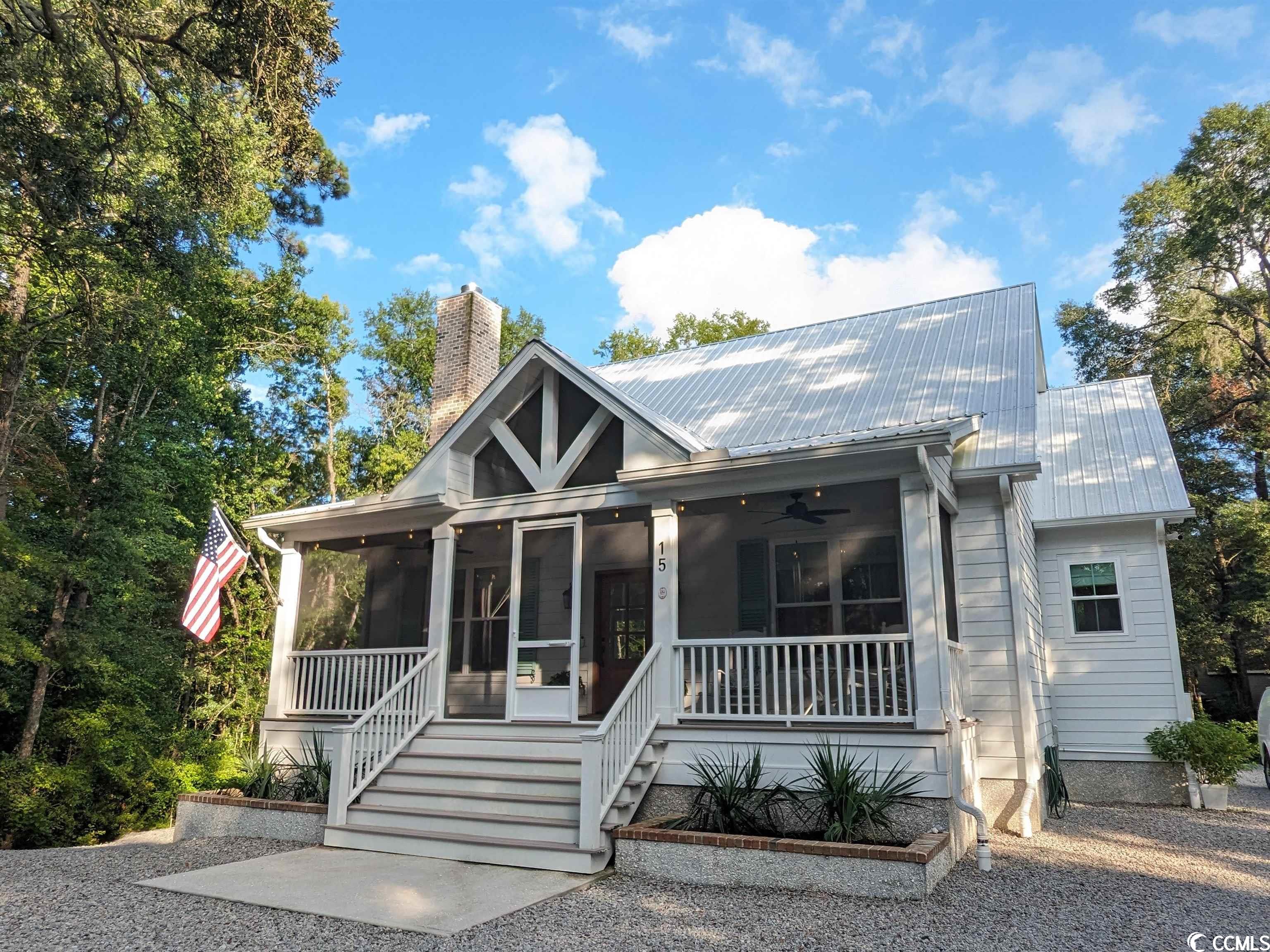 welcome to this beautifully designed 2022 coastal luxury cottage nestled perfectly against the protected intracoastal waterway creek in pawleys island. positioned in a historically and unique area which was once part of the original heritage plantation stage coach entrance. the back of this property is highlighted by the abundant natural beauty of wildlife and protected cypress wetlands that can never be developed. this icw tidal creek can be accessed by kayak from the property and enjoy a paddle into the intracoastal waterway, see picture. this construction project is highlighted by 20 plus years of real estate, new construction and interior design experience by the developers. the property received its certificate of occupancy in 2022 with recent improvements for final completion were just made in 2023 with upgrades to the landscaping and other home features. the attention to details and choice of materials will be greatly appreciated to the discerning eye. 3100 sq ft of heated and 1400 sq ft of 3 separate screened in structural porches and golf cart garage - perfect for the southern living and making this a total of 4500 sq ft covered.  3 bedroom with their own on-suites and 2 non-conforming bedrooms one with kitchenette. here is a list of some of the features: isokern wood burning brick fireplace with solid wood floating mantle, clear pine ship-lap throughout, solid wood beams, james hardie cement siding, engineered foundation with pumped cinder block/re bar and slab foundation, eco-friendly fiberglass insulation, trex decking on all 3 covered and screened porches, metal roof/fascia, concrete soffit, 400 amp electrical service, underground utilities, full rv hookups for class a motor home, large boat and/or equipment parking, golf cart garage parking and workshop, whole house generac backup generator with 400 amp automatic transfer switch, fountain, arbor, 9 fruit trees and 18 berry bushes, a beautiful rose garden, 3 screened in porches, ltv flooring, designer kitchen with ge cafe series smart appliances, bi-fold designer kitchen window that opens up to back deck bar counter, 4 smart outdoor security cameras, large 3 window-pane slider to back covered porch indoor outdoor living, commercial rated hood vent duct, gas stove, island with beverage center, 500 gallon buried propane tank, solid oak treads and oak hand railings, walk-in pantry with appliance quartz counter, separate laundry room with storage closet, solid counters throughout, dual sinks in main bath with separate tub and walk in shower, main bedroom walk in shower has slider to access outdoor shower too, 3 bedrooms with on-suites, each bedroom has direct access to one of the 3 porches, guest and/or in-law room with kitchenette, theater room with professional surround sound and smart projector, tank-less propane water heater, all 3 levels have their own hvac zones and much more. this low maintenance home would also make a great 2nd home or excellent short term vacation rental. come home to a peaceful and private location close to it all.