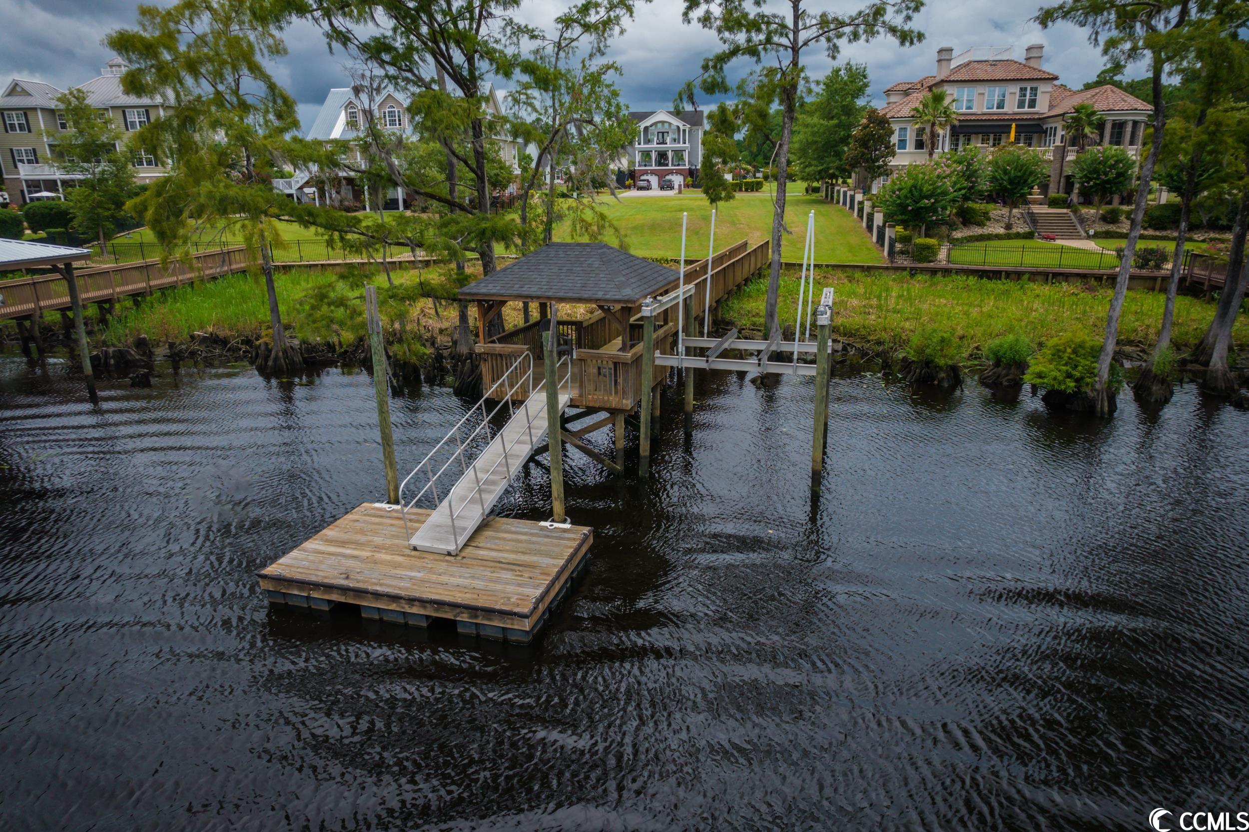 this is the river-front property you have been waiting for!!! build your dream home on this half acre, cleared and ready, river lot with its own seawall, pier, covered deck over water, floating dock, and its very own boat lift. no timeframe to build in pottery landing which is one of the most desired private communities on the waccamaw river. pottery landing boasts a beautiful gated entry and its own private boat ramp with neighborhood dock, as well as an amenity center with kitchen, bath rooms, large gathering room and a large neighborhood swimming pool.   the is nothing more beautiful than this section of the river and this lot offers the perfect place to build the home you've been dreaming of. from this property you can boat into downtown conway, or even make your way to the intercoastal waterway with out any bridges to block your way.   just a short drive to conway and only 30 minutes to all of the shopping, dining, and area beaches!!!  do not hesitate, a desirable river lot like this will not last long!!!