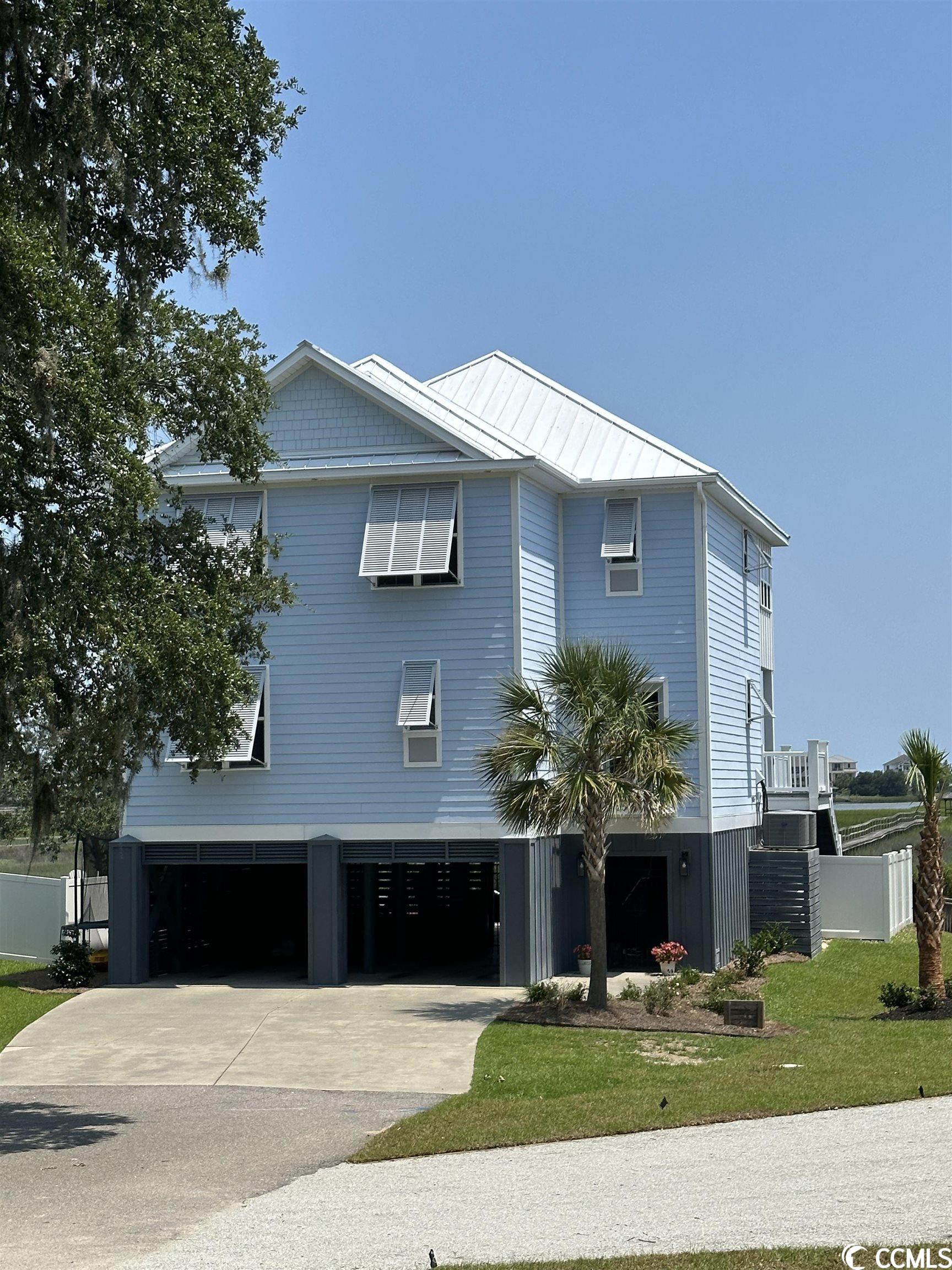 come fall in love with an unobstructed view of midway inlet and ocean views of south litchfield and north pawleys with this creekfront home! enjoy a panoramic view of the sunrise, bald eagles, thunderstorms, and much more from the comfort of your home. this custom home is built on driven pilings and offers 4 bedrooms, 3 baths and a bunkbed nook to accommodate many guests. the spacious master suite includes a trey ceiling, large custom closet, shower with body jets, sitting area and private deck. open concept design, custom cabinetry, crown molding, 3/4 inch hardwood flooring, standing seam metal roof, storm protection for all exposed windows and doors, an elevator serving all floors, outdoor shower and much more. 5 min drive to pawleys or litchfield beaches. there is a community dock that is shared by 3 other lots. plenty of storage under this raised style house with pool and private gate to the dock.