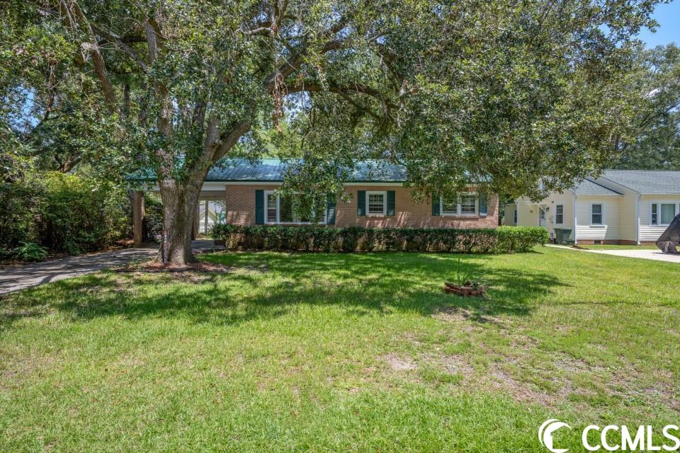 don't miss this opportunity to own this 2 bedroom, 1 bathroom home with a possible 3rd bedroom in the heart of conway! this no hoa home features features a fresh coat of paint with updated storm doors and window, and original hardwood flooring throughout most of the home, with vinyl in the kitchen and bathroom. a metal roof, a great size yard with an extra large detached 2 car garage with electric added in 2017, moisture barrier and lighting in the crawlspace, friendly neighbors, and a chimney for a gas fireplace... with good bones, and an incredible location, add a little tlc, this home will make the perfect forever home! perfectly situated less than 5 minutes to downtown conway, the famous riverwalk's dining and attractions, schools, grocery stores, coastal carolina, hgtc, and more! schedule your showing today!