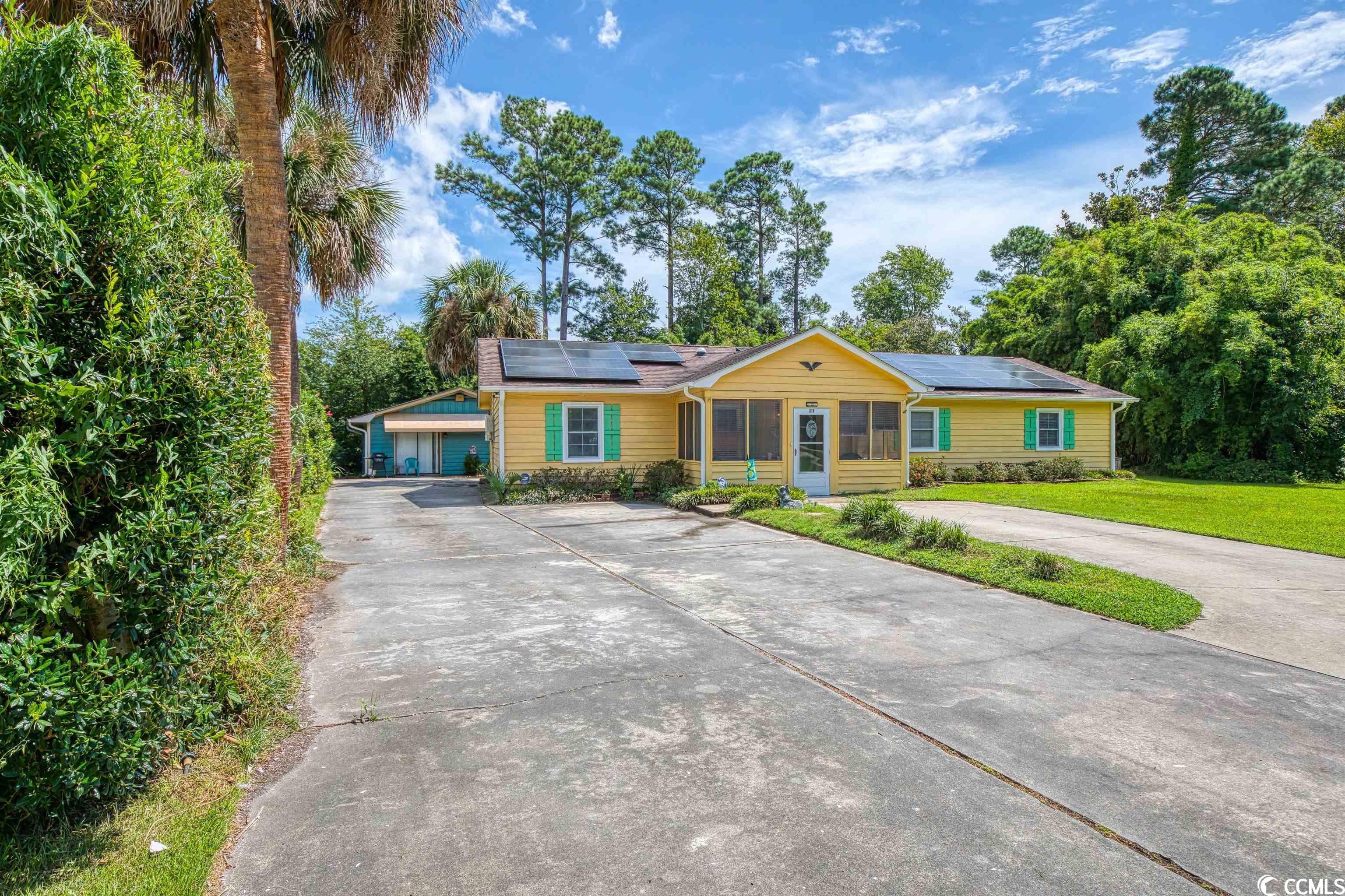 come check out 219 misty pine drive with a detached mother in law suite or rental opportunity, located approximately one mile from surfside beach! this home sits on a quiet cul-de-sac providing two large driveways in the front of the home and additional driveway on the right side of the home leading to a concrete pad perfect for storing your rv, boat, golf cart and any other toys you may have, a large fenced in backyard, two storage sheds, a screened in front porch, a back concrete patio and back deck! on the outside of this home, you will find solar panels, gutters, 2 hvac units, motion sensor lights, and an additional storage facility off of the back of the home where the water heater is located. you will be excited to tour the additional home on the property that is currently used as a short-term rental. it has a full kitchen, full bathroom, one bedroom, a living/dining area, washer and dryer room and its own fenced in yard and patio! moving into the home, you will enter through a screened in porch where you can enjoy your morning coffee before gathering your belongings and heading to the beach. entering the home, you are greeted by a foyer and a coat closet, on the left you will walk through double doors to a room that is currently a bedroom, however this room can be used as a formal dining room, office or study, the opportunities are endless for your needs! the kitchen features granite countertops, upgraded kitchen cabinets, a double oven, stainless steel appliances and ample storage. off of the kitchen is one of the ensuites in the home and the bathroom has an upgraded walk-in shower with dual shower heads. walking back through the kitchen you will enjoy the family room and dining area combination perfect for enjoying the company of others. the beautiful brick, wood burning fireplace and vaulted ceilings with wood beams boasts old charm that brings warmth and comfort. off of the family room is the laundry room and additional storage room with access to the attic. walking to the right side of the house, down the hallway is a guest bathroom, hall closet and three additional bedrooms. one of the three additional bedrooms features a second ensuite and doors leading to the bright oversized carolina room, perfect for enjoying games and game day with your friends and family. the owners have maximized the space by adding multiple beds to the rooms. you don’t want to miss the opportunity to own this rare home!!  all measurements are estimated and should be verified by buyer(s). buyer agent/buyer to verify all hoa information and square footage.