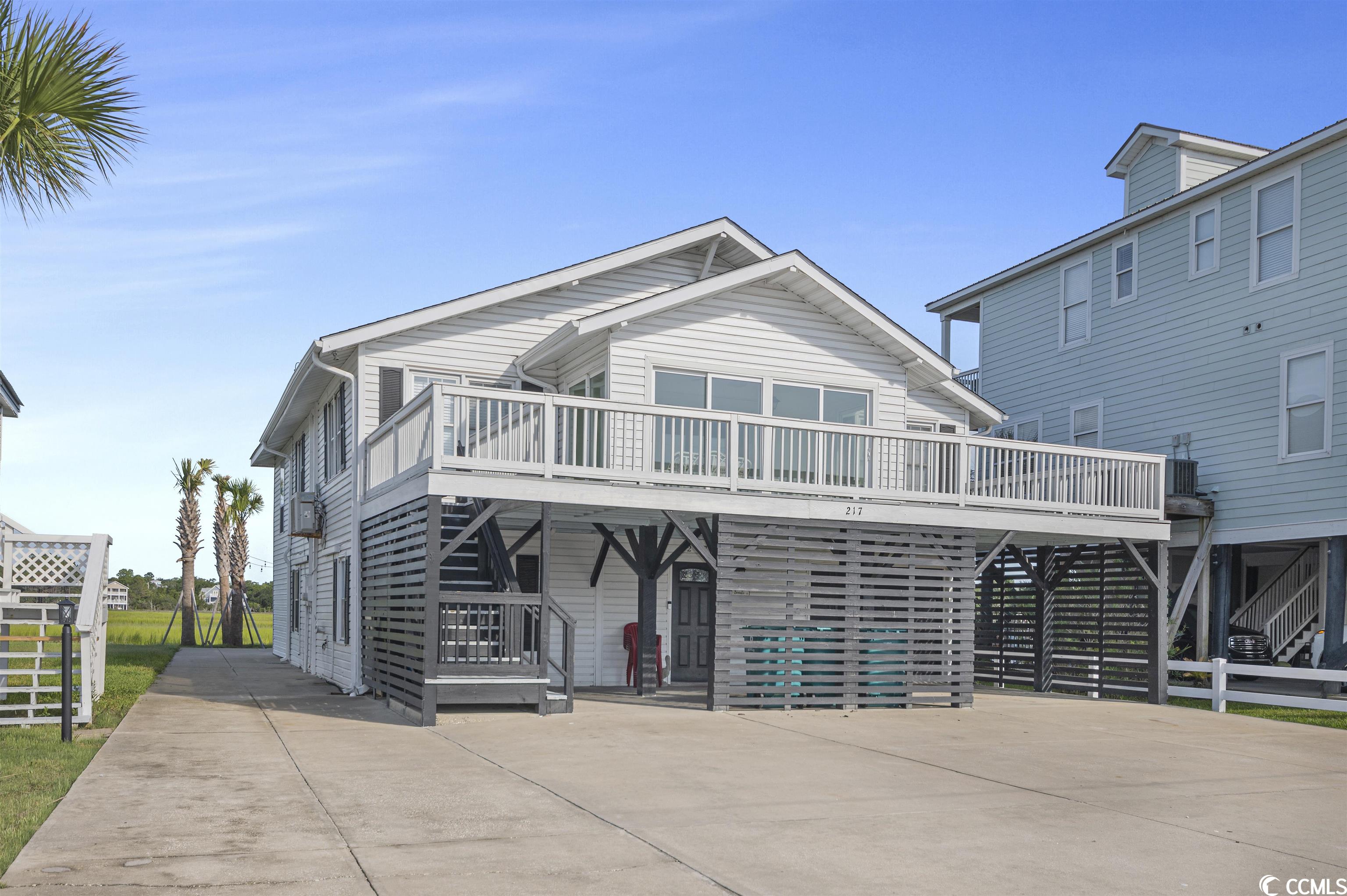 this 5 bedroom, 4 bathroom home is ideally located directly on the marsh and only one block from the beach! bring all of your family and friends to enjoy creekfront living in this home that comfortably sleeps 16. everyone can access the home with ease, with your very own elevator and enough boat, rv, car, and motorcycle parking for 8+ vehicles! enjoy sunrises from the spacious front porch or sunroom and beautiful sunsets over the marsh on the back porch or from the carolina room off the kitchen. go kayaking, paddleboarding, or fish off your fishing dock right in your own backyard. just a short drive to all of the golf the area has to offer, five minutes to murrells inlet marshwalk with waterfront dining and events, and a five minute walk to the garden city pier. this popular vacation rental also has over 25+ five star reviews and is the perfect turn-key investment or tranquil place to call home. home will convey fully furnished.