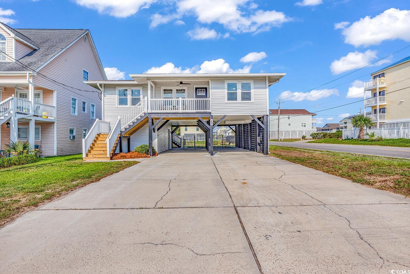 cherry grove channel front home one block from the beach!! welcome to one of the funnest and best places to live on the sc coast (cherry grove beach)! fish, kayak, boat all from the channel behind your house! walk to the beach to enjoy some of the most stunning sunsets and sunrises! walk to cherry grove pier or boulineaus for breakfast or lunch!! walk or ride your golf cart to od (main street) where you can enjoy live music, shag dancing, restaurants, shopping and tons of entertainment!! you are minutes from just about any shopping, grocery store, or  restaurant you would need! a few miles from little river and the intracoastal waterway and about 20 minutes from calabash and sunset beach nc! this is a convenient area to lots of fun coastal places and beachy towns but honestly you may not want to leave cherry grove very much it’s got all the beach vibes and fun you need!  this home was just beautifully renovated inside and out!! renovations were professionally done by a local builder “blue wave construction”!!  renovations include: new gas tankless hot water heater, new gutters, new front and back porches with new staircases with new vinyl railings. fenced in the backyard with 4’ gate under the house and at the water and 2-5’ gates to make a 10’ opening on the roadside to access the large back yard. the storage room has a new toilet, sink and a washer and dryer that all have been “grandfathered” in by the nmb inspection department. upstairs~refinished the hardwood floors, installed all new cabinets with soft close doors and drawers, new quartz counter tops and tile backsplash that goes all the way to the ceiling around the windows. all new stainless steel samsung appliances.  added a storage closet with shelving and outlets for the internet boxes etc. and to charge vacuums. all new doors inside and out.  replaced the bathtub and tiled the walls with a large niche, sheet rocked the bathrooms and installed new toilets and sinks. in the master bath they took out a window and installed a walk-in shower with frameless slider doors and tiled bathroom floor as well.  all new light fixtures throughout the house including ceiling fans in all bedrooms and two in the main living area. new ceiling fans on the porches too. installed new electrical boxes and located them in the storage room downstairs instead of the kitchen.  owners had the roof and hvac inspected and new freon installed in the hvac because they had to drain it to build the new porch. they also matched the siding where we took the window out, special ordered the knotted pine to fix areas where needed in the house. the property has been reinforced in the storage area that you can see as well as all new plumbing. they leveled and replaced 5 piers under the house. new wooden slats were added on the roadside for privacy and added the outdoor shower with hot and cold water and it has a ledge for shampoo/ conditioner and added a bench!! if you are looking for a truly beautiful renovated home close to the beach and on an awesome channel be sure to look at this home!!  300 46th ave. n. north myrtle beach, sc 29582.