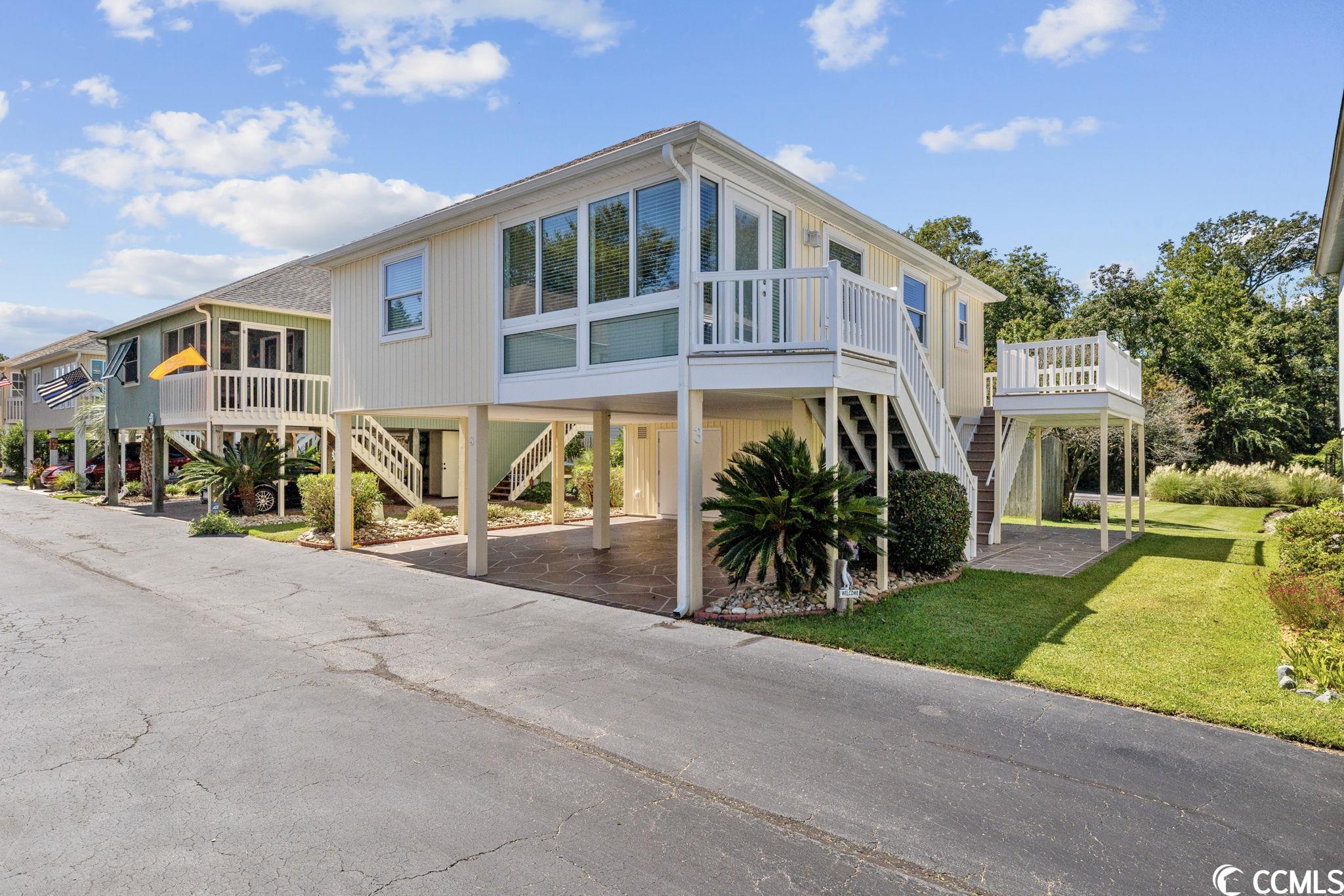 due to no fault of the seller, property is back on the market.***location, location, location!! golf cart to the beach! welcome to this meticulously maintained 2 bedrooms 2 bath raised beach home located in the heart of north myrtle beach.  located just a half mile from the ocean, it offers easy access to the beach and all the fun of coastal living. some might say it's the best hidden place in north myrtle beach! this cozy raised beach house features a split floor plan- 2 bedrooms and 2 baths, perfect for a small family or group of friends. the house has a comfortable living room, a fully equipped kitchen which boasts granite countertops and stainless-steel appliances, and a living room/dining area. also, both bedrooms are tastefully furnished and offer plenty of storage space. there's also a 7 x 11 carolina room, which can be a versatile space for relaxation or extra seating. this beautiful beach house has so many extras to enjoy with several outdoor living spaces, which can be used for lounging, dining, or simply relaxing! trex decking, vinyl siding, which is low-maintenance and can withstand coastal conditions for years to come. attached storage shed on ground floor to hold all of your beach gear, bicycles, kayaks, surfboards, golf clubs and/or tools. new ac unit condenser/air handler as of sept 2023. amenities included are outdoor community pool, clubhouse. call to book your scheduled showing today!!