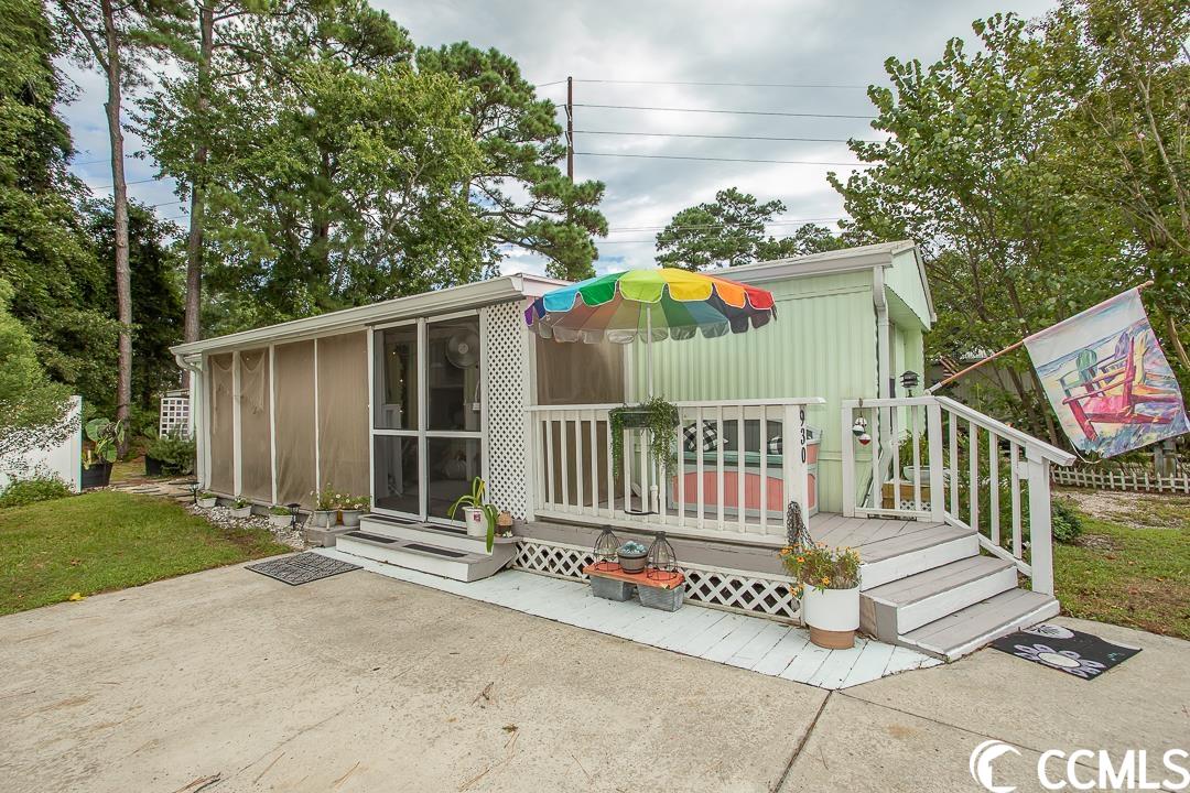 welcome to this charming 2-bedroom, 2-bathroom mobile home that offers a unique blend of comfort and convenience. nestled within a peaceful community, this super cute mobile home boasts a variety of features that make it a truly inviting space to call your own.  the quaint porch is perfect for enjoying your morning coffee or evening relaxation. the property is beautifully embraced by courtyard fencing, providing both privacy and a touch of coziness to your outdoor space.  one of the standout features of this property is the 150 square foot barn, complete with an attached shed. this additional space offers versatility and storage options to suit your needs, whether you're an avid gardener, diy enthusiast, or simply in need of extra storage space.  positioned against a backdrop of a wooded area, you'll enjoy the tranquility of having no neighbors directly behind your home. this natural barrier creates a serene atmosphere and a sense of retreat, allowing you to unwind and appreciate the outdoors in peace.  convenience is also key with plenty of parking available for you and your guests. the added bonus of an outdoor shower provides the perfect solution for rinsing off after a day at the beach, keeping your interior space pristine.  step inside, and you'll find a thoughtfully designed interior. with a functional barn door that elegantly closes off to reveal a spacious master suite, adding a touch of rustic charm to the living space.  the upgraded ac ensures year round comfort, while a recently replaced water heater guarantees a reliable supply of hot water. comes with your own outdoor shower to rinse off after a day at the beach.  recent upgrades include newly replaced gutters, a disposal unit, and modern interior doors that breathe new life into the space.  located in the desirable foxfire community, this area is known for its golf cart-friendly environment, allowing for convenient and enjoyable travel within the neighborhood. moreover, the mobile home is perfectly situated just one mile from the beach, offering you easy access to the shoreline and all the joys of coastal living. with its strategic location, you'll also find yourself close to a plethora of amenities, making daily errands and leisure activities a breeze.  don't miss out on this opportunity to own a mobile home that effortlessly combines comfort, style, and a prime location. experience the joys of coastal living while enjoying the conveniences and unique features this property has to offer.