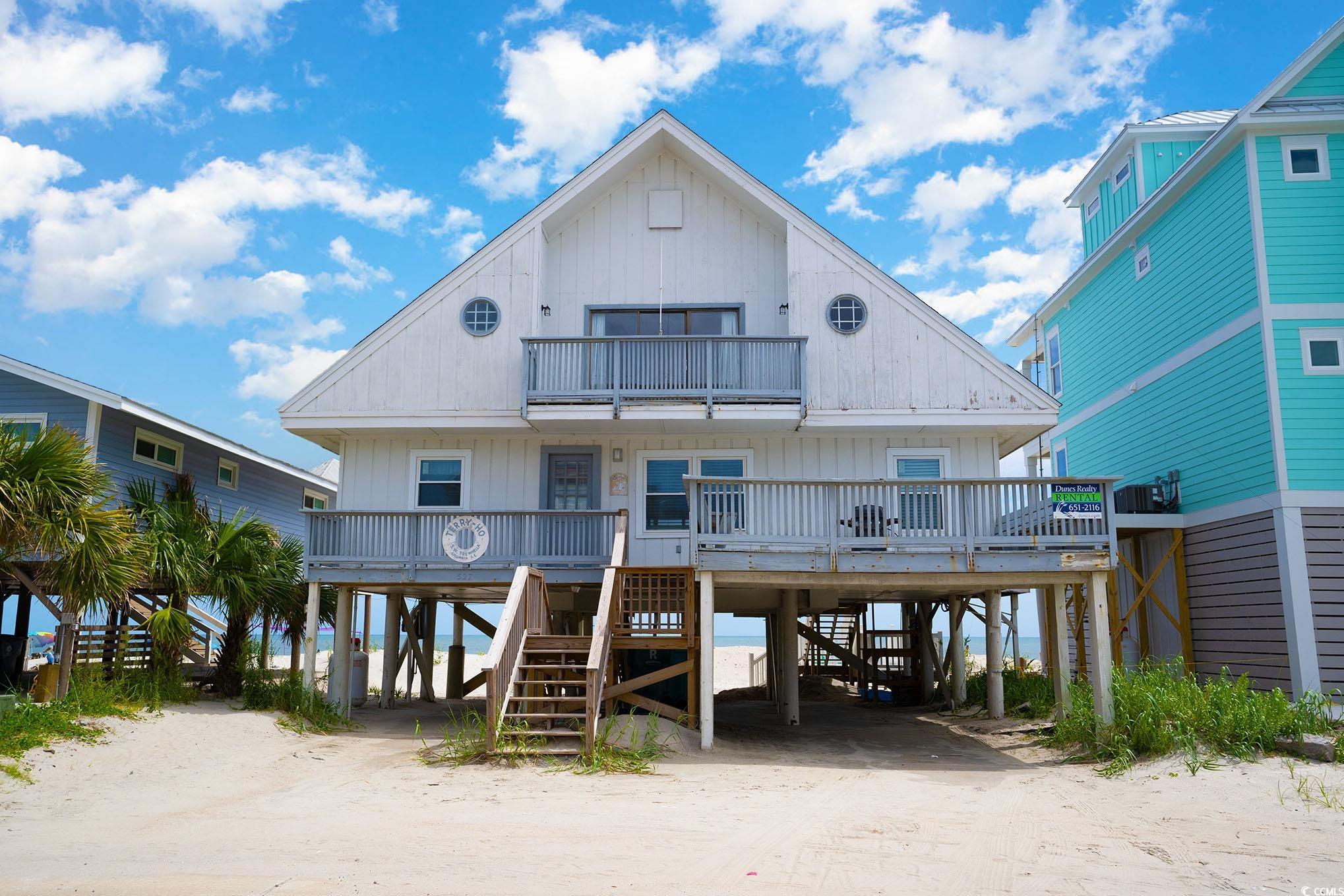 relaxing oceanfront year round beach property, a close walk or golf cart ride to garden city pier, arcade, ice cream shop and restaurants. imagine waking up with views of the beautiful atlantic ocean. walk out your backdoor and relax on your screened deck area with an oceanfront view or walk down your private path straight to the sand. love the vacation life with this 5 bedroom 4 bath home with plenty of natural lighting and lots of balcony/deck space to enjoy. the master room has an amazing must see view. the home is being sold completely furnished. amazing opportunity for a second home or  investment for short term rentals. come see all the this home has to offer in beautiful garden city.