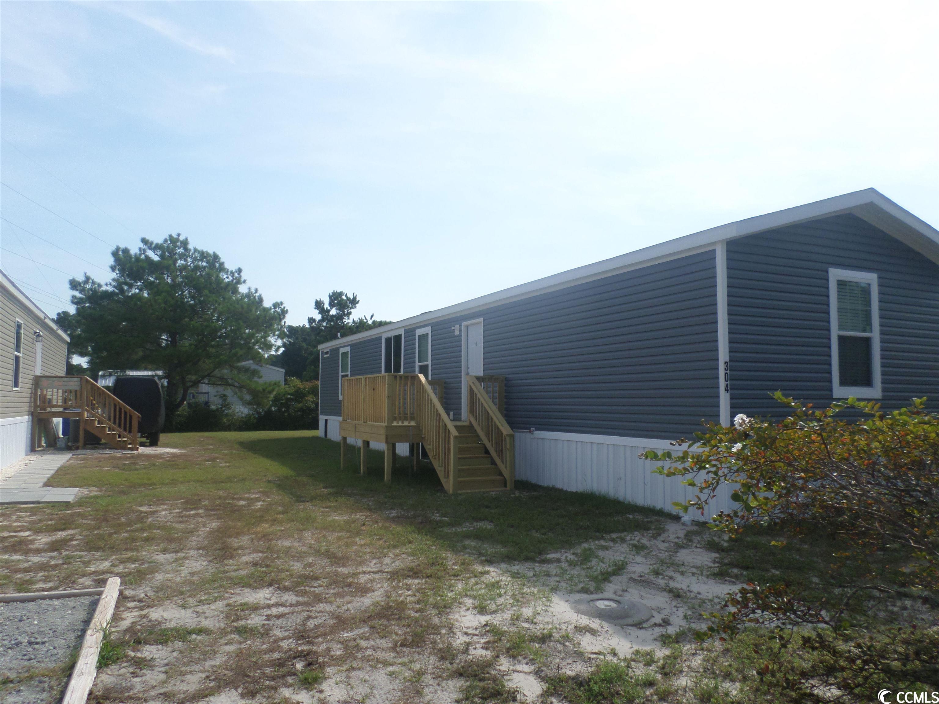 this beautiful new 3 bedroom 2 bath manufactured home is set up in the sought after creekside north myrtle beach community that offers amenities to include a pool, clubhouse, playground, and community mail boxes. creekside is a leased lot community which is close to the intracoastal waterway and atlantic ocean. the decks on the front and rear of the home are great for relaxation and entertaining. the home is finished off with vinyl under skirting and will provide protection for the crawl space foundation  and give a splash of additional curb appeal. as you enter the home, you walk into the living room, and to your left is the open kitchen with plenty of shelves with an island kitchen bar. the home has a split bedroom plan with master walk in closet and double sinks. the farmhouse kitchen sink is lovely and has plenty of space. a one year manufacturer's home warranty is being offered to the buyer. this lovely charmer is a must see today.