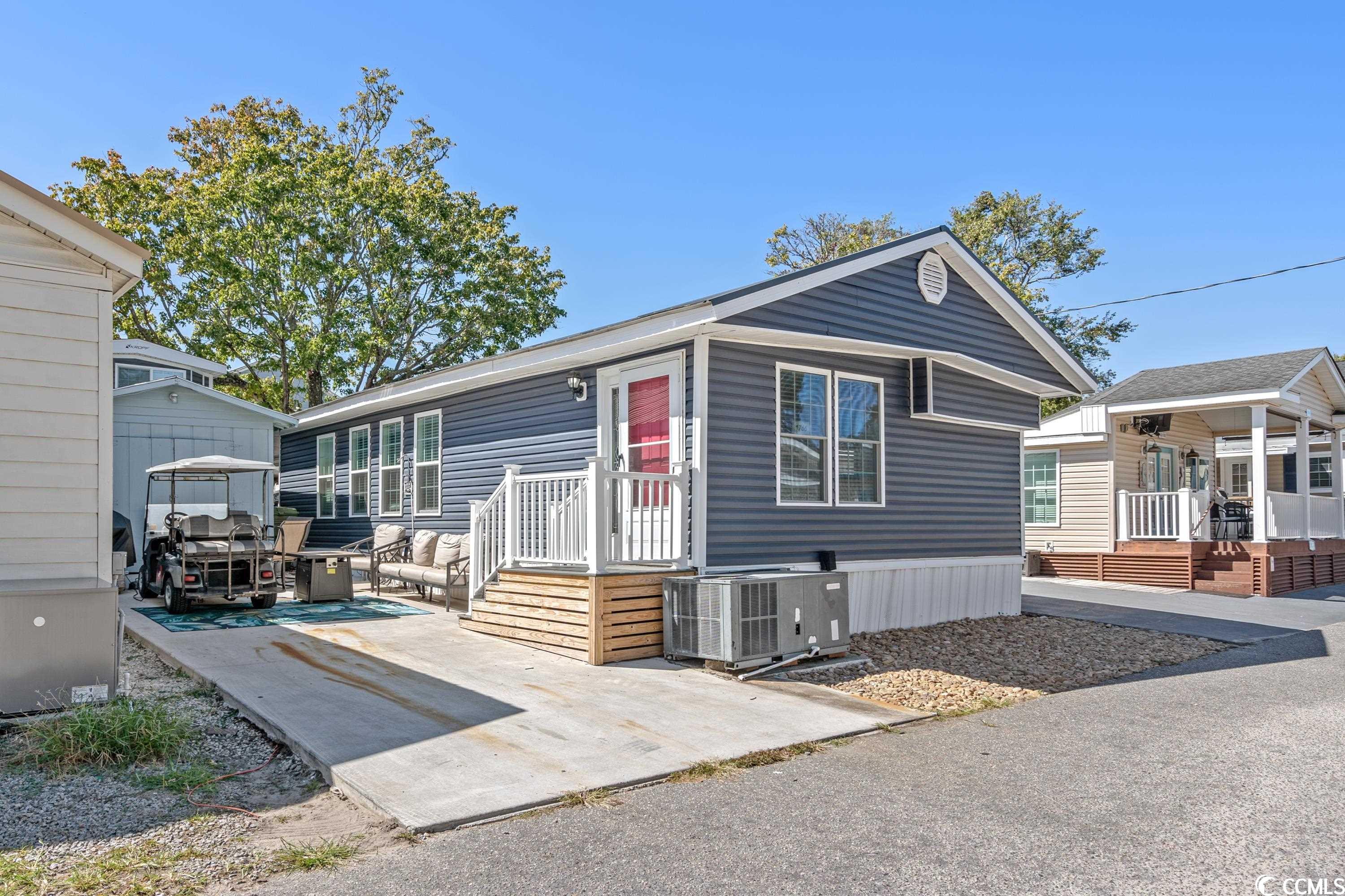 new vinyl siding, windows, concrete, porch, outdoor furniture, front door and storm door in 2023, new lvp flooring in 2 bedrooms.