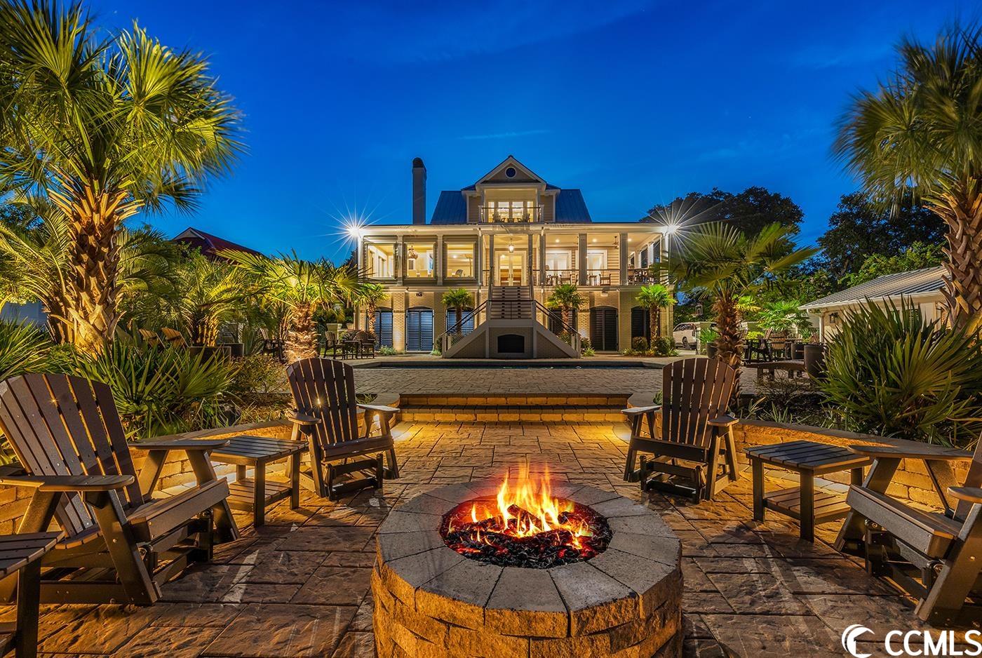 welcome to paradise, a rare and unique opportunity to embrace coastal living in murrells inlet at its finest!! situated on a sprawling one-acre lot with beautiful majestic live oaks, this exquisite residence boasts breathtaking views of the inlet, channel, and ocean. as you step inside, you'll be captivated by the grandeur of this home. the hickory hardwood floors throughout add warmth and elegance, while the true custom cabinets and brick fireplace create an inviting ambiance. this open concept is perfect for entertaining! the kitchen is absolutely mesmerizing, complete with wolfe six burner gas range, subzero fridge & freezer, custom hood, and tiled back splash. there is also an under counter wine fridge & ice maker along with custom wine display showcase. the elegant light fixtures and furnishings throughout this home along with the remarkable craftsmanship and custom moldings are truly a work of art. the two guest bedrooms on the main floor each have there own private baths and doorways leading to the wrap around porch ensuring comfort and convenience for all. the master suite on the third floor is a haven of tranquility, complete with spacious his and hers walk-in closets and custom built-in shelving, additional washer and dryer, mini fridge and you guessed it an ice maker. the en-suite bath is absolutely stunning and features a standalone soaking tub, dual vanities, and a custom pebbled floor tiled shower. this property offers an array of luxurious amenities, including an elevator for easy access to all levels. the outdoor kitchen and entertaining area provide the perfect setting for hosting gatherings with family and friends. take a dip in the swimming pool or relax on the porch or patio while enjoying the serene unrivaled waterfront views. additional features include: wrought iron electric gated entry way, a whole house cummings generator, tankless renai hot water heater, bar, private dock, wireless bluetooth sonos surround speakers throughout, standing seam metal roofing, outdoor gas heaters around pool, outdoor gas firepit, security system, landscape lighting, urc controlled smart home, custom remote control automatic blinds, trex composite decking on porches, restoration hardware light fixtures and much more!! don't miss out on this exceptional opportunity to own a piece of paradise. schedule your showing today and experience coastal living at its finest in this remarkable waterfront home.