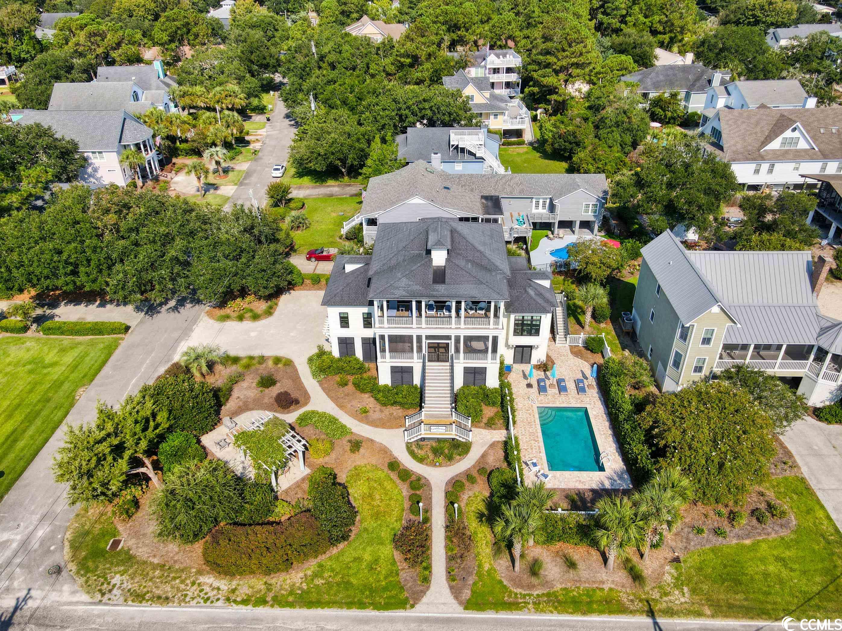 welcome to 611 parker drive in pawleys island’s sought-after north litchfield beach community. if you have ever taken a drive along the beach in north litchfield, you have most likely noticed the “casablanca” home. this one-of-a-kind custom beach house, designed by steve goggans, is located on a large corner lot with expansive ocean views.   the white hardie board siding and black trimmed windows give the exterior a luxurious coastal appeal and the grounds have been thoughtfully designed and landscaped. owners and guests have an in-ground pool for cooling off after a day in the sun and a fire-pit for enjoying fall evenings at the beach, plus a gazebo with dining area. this single-owner house has never been rented and has been meticulously maintained and cared for.  the front path leading from casablanca goes directly to the beach walkway and ocean. no houses block views due to dedicated space.  conveniently, all three levels of the home have elevator access and the garage has plenty of room for multiple vehicles, golf carts and beach supplies. the master bedroom is located on the upper level of the home to take advantage of the ocean views. also upstairs, is a large recreational room / pool hall with a half bath, bar area, and an extra room used as an art studio, all with direct access to an expansive deck overlooking the atlantic. (note: the pool hall area could be converted into another master bedroom with full shower).  on the main level of the home, you will find a spacious living area with wood flooring and a cozy gas fireplace that flows perfectly into the kitchen and dining area. the kitchen features stainless appliances, a gas range, glass tile backsplash, glass-paneled cabinetry and bar-top seating with beautiful quartz counters. two more bedrooms are located on the main level, each with private baths and attractive tile flooring.  double doors lead from the living area out to the front screened porch, large enough for dining and entertaining while enjoying the sounds of the ocean.  other notable features include: an outdoor shower, landscape irrigation and a private office off the kitchen. don’t miss this unique opportunity to own one of the finest custom homes ever constructed along litchfield beach.