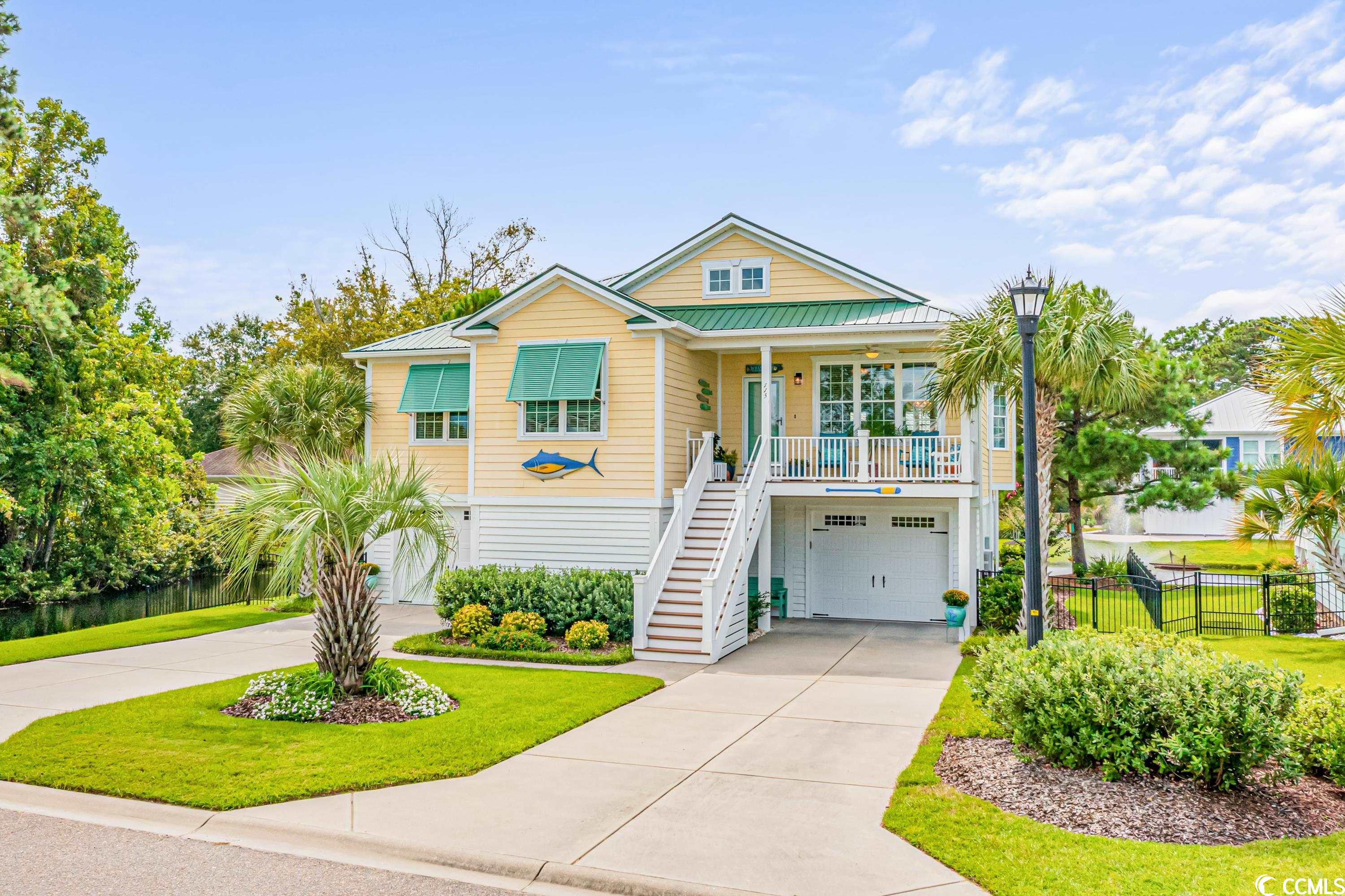 rare opportunity to own this unique and beautiful raised beach house located in a 28 -home boutique community less than a mile to the beach.  this golf cart friendly natural gas community at reflection pointe is an ideal location and setting for the buyer who requires an oversized garage to store their vehicles, trucks, golf carts, trailer, motorcycles and more.  the lower level garage measures 46'6" across and 37'6" deep with several storage closets in the center of the garage. there is even a workbench area as well for the handyman and a rinnai tankless hot water heater. this coastal property enjoys serene pond views with a fountain. as you enter the home, the open concept living space is so pretty with the vaulted ceilings, natural gas fireplace and custom bookcases on either side of the fireplace. the dining area features crown molding and sun drenched with natural lighting. the kitchen is perfect for entertaining with white cabinetry, center island, granite counters, back splash and stainless appliances including a gas stove. the primary suite is spacious with a large custom closet design for his/her areas. the primary bath offers tile floors, separate tiled shower, soaking tub, and double vanity with granite counters. two good size bedrooms offer carpet, ceiling fans and double closets.  seller uses one bedroom as an office and the murphy bed works well to conserve space. hall bathroom offers tile floors, tub/shower, vanity with granite counters and some wall wainscoting. you can access the garage with the stairwell in the home located to the left of the front entrance. trex decking adorns the front and back decks.  enjoy the peaceful and serene pond views from your back porch, read a book and watch the fountain all the while protected from the sun with an awning. did i say the pond is stocked with fish! the exterior of the home is hardie board and accented with bermuda shutters. the main living areas and primary bedroom showcases a high grade laminate wood finish flooring. this 3 bedroom, 2.5 bath beach property checks all the boxes with open floor plan, proximity to the beach, outdoor living, golf cart community and tons of garage space.  there is a community pool, too!  call for your private showing today!