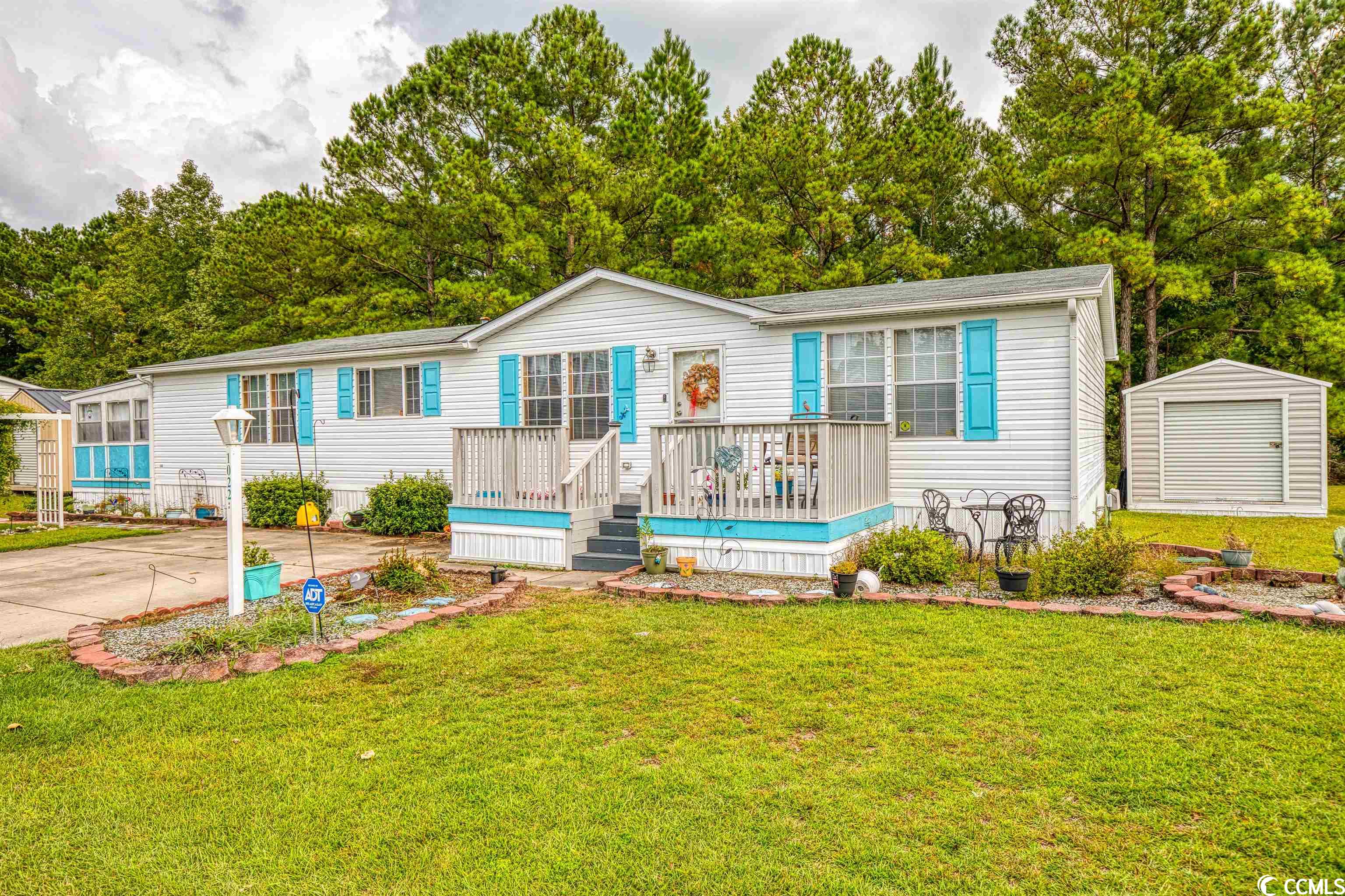 this generous sized home has been meticulously maintained and features a split bedroom floor plan all on one level. the living area features vaulted ceilings as well as vinyl flooring throughout, aside from the master bedroom. the kitchen has plenty of counter space, along with a built in office area perfect for the kids to do their homework! looking for a perfect backyard? well here it is, backing up to a natural border of trees and water makes the extended back porch one of the best places to spend your time! this home also features a beautiful carolina room, as well as two large outdoor sheds that convey with the property! you do not want to miss this, so schedule your showing today!
