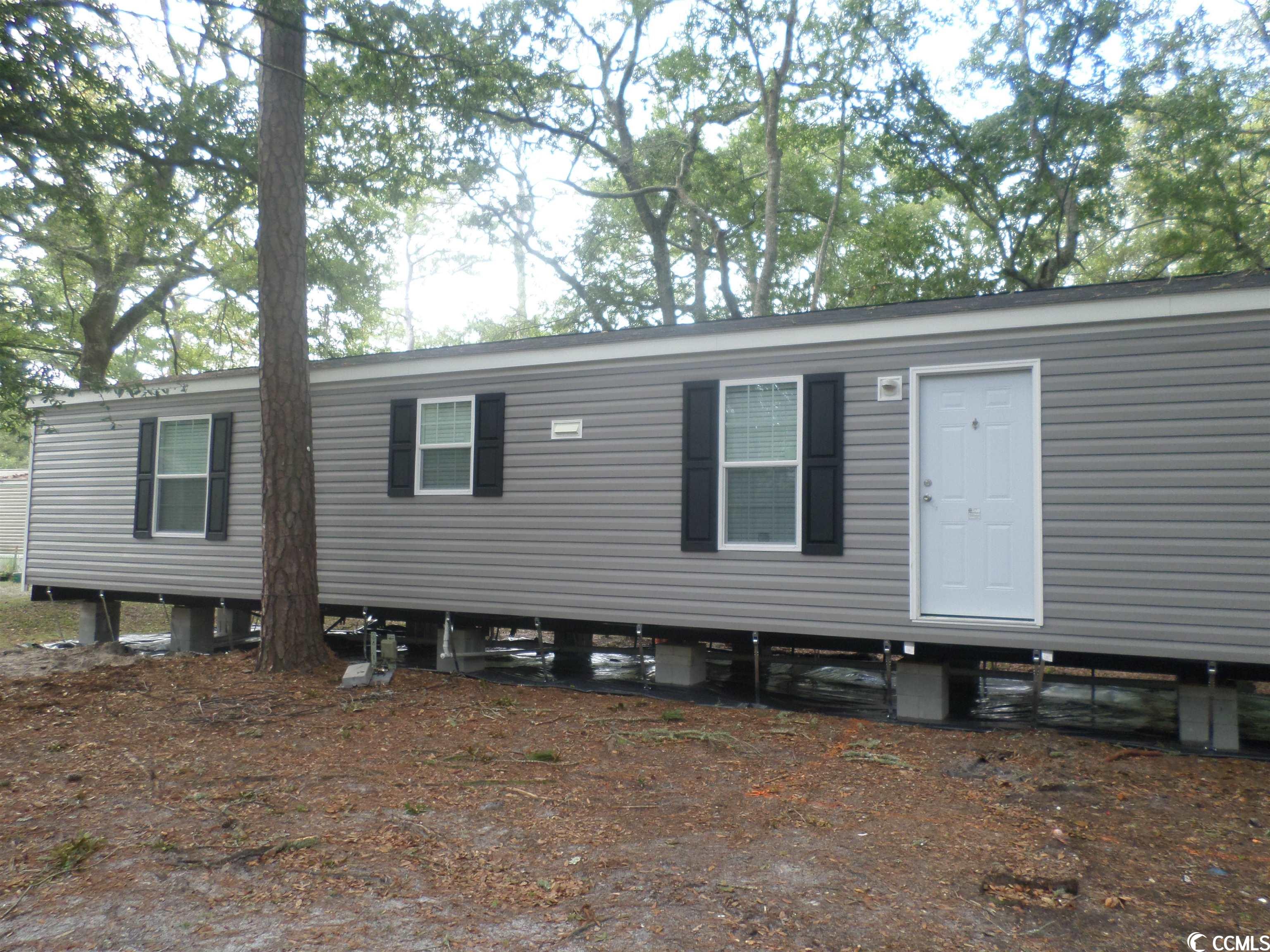 this beautiful new 3 bedroom 2 bath manufactured home is being set up in the sought after creekside north myrtle beach community that offers amenities to include a pool, clubhouse, playground, and community mail boxes. creekside is a leased lot community where manufactured home owners reside close to the atlantic ocean and intracoastal waterway. the decks on the front and rear of the home are great for relaxation and entertaining. the home is being finished off with vinyl under skirting once power is obtained in the near future and will provide protection for the crawl space foundation and give a splash of additional curb appeal. a manufacturer's home warranty is being offered to the buyer.  the home is being offered as a primary residence or vacation home. this lovely charmer is a must see today.