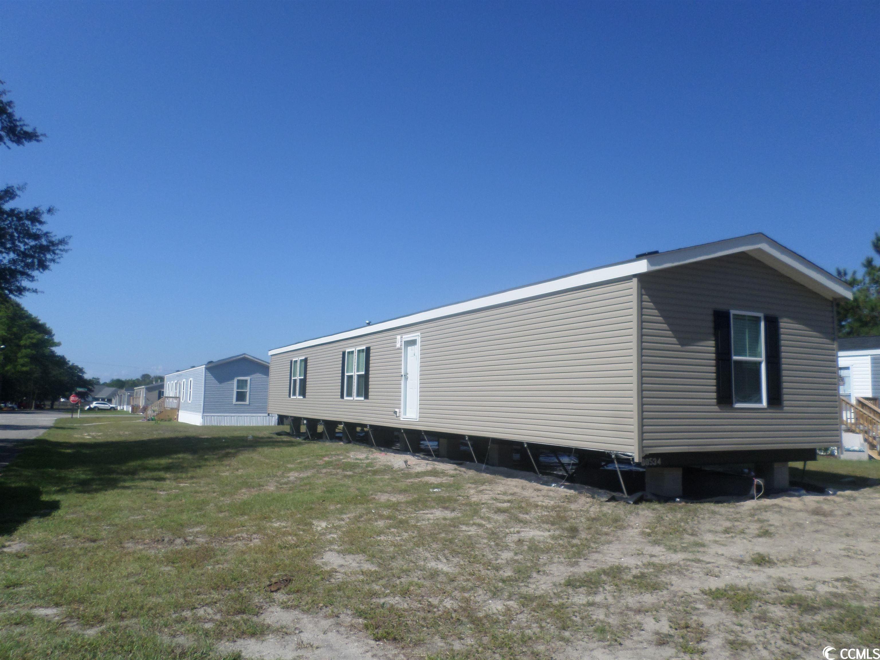 this lovely 3 bedroom 2 bath new manufactured home is being set up with front and rear decks, vinyl under-skirting and will have power, water and sewer upon completion. creekside is a leased lot community is located in the cherry grove section of n. myrtle beach, sc and is only minutes from the intracoastal waterway and atlantic ocean.  a manufacturer's warranty, manufactured home title transfer to buyer and new horry county tax sticker is all included in the sale price of the home. creekside community has amenities to include a swimming pool, onsite mail boxes, playground area and clubhouse. this home is being offered as a permanent residence or vacation home. it's a must see today.