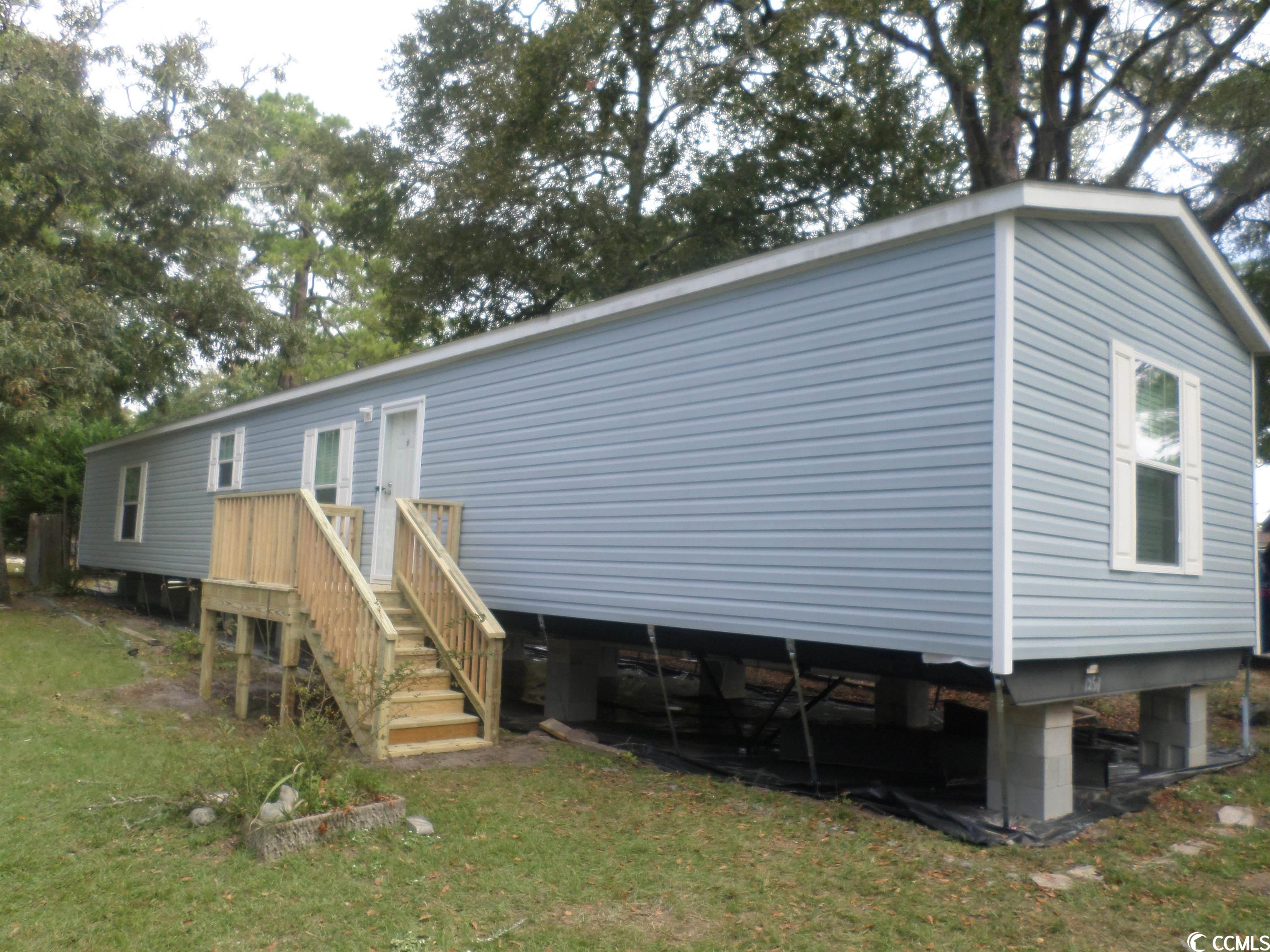 this lovely 3 bedroom 2 bath new sheetrock manufactured home is being set up with front and rear decks, vinyl under-skirting and will have power, water and sewer upon completion. creekside is a leased lot community is located in the cherry grove section of n. myrtle beach, sc and is only minutes from the intracoastal waterway and atlantic ocean.  a manufacturer's warranty, manufactured home title transfer to buyer and new horry county tax sticker is all included in the sales price of the home. the lovely home has a large kitchen with plenty of cabinets and storage, an appliance package, ceiling fans, blinds and neutral color tones for matching any furniture or decor.   the lot is a double sized lot and you would park on the back side of the home. there is rear privacy fence on the side yard already in place. creekside community has amenities to include a swimming pool, onsite mail boxes, playground area and clubhouse. this home is being offered as a permanent residence or vacation home. it's a must see today.