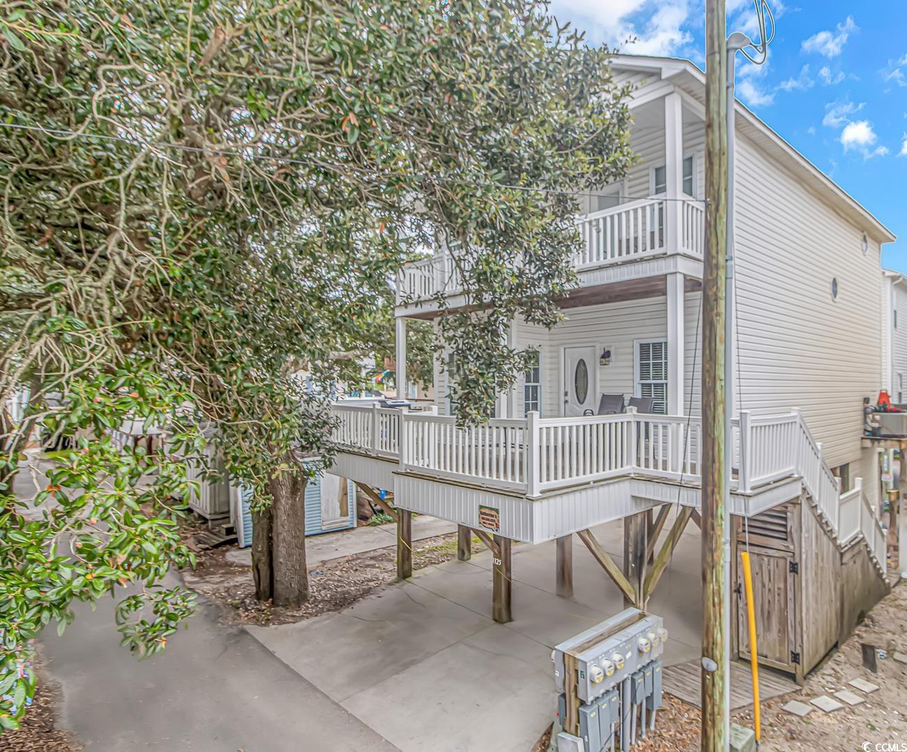 impressive 5 bedroom 3.5 bath home located within steps of the beautiful atlantic ocean! located behind the gates of the award winning ocean lakes family campground, site 1125 is offering double decks, ample parking, a spacious living room, kitchen, and a great location within the park. as you enter the home, you're greeted by a spacious living room that offers laminate flooring, a generously sized eat-in kitchen, first floor primary bedroom and bathroom along with a half bath downstairs. with a private primary suite offering a jacuzzi tub and plenty of space to get ready, this home was designed to offer all the comforts of home. upstairs there are 4 additional bedrooms along with 2 bathrooms. two of the upstairs bedrooms lead out to the private balcony. sit back and enjoy watching the golf carts go by! with excellent rental history, this home offers countless opportunities for investment purposes! perfect for anyone, this home is ideally positioned to enjoy summers by the south carolina coast. home is conveniently located close to all the amazing amenities ocean lakes has to offer! amenities included are indoor/outdoor pools, lazy river, waterpark, mini-golf, arcade, basketball courts, volleyball courts, and much more! come check out this property today! all measurements are approximate and not guaranteed. buyer responsible for verification.