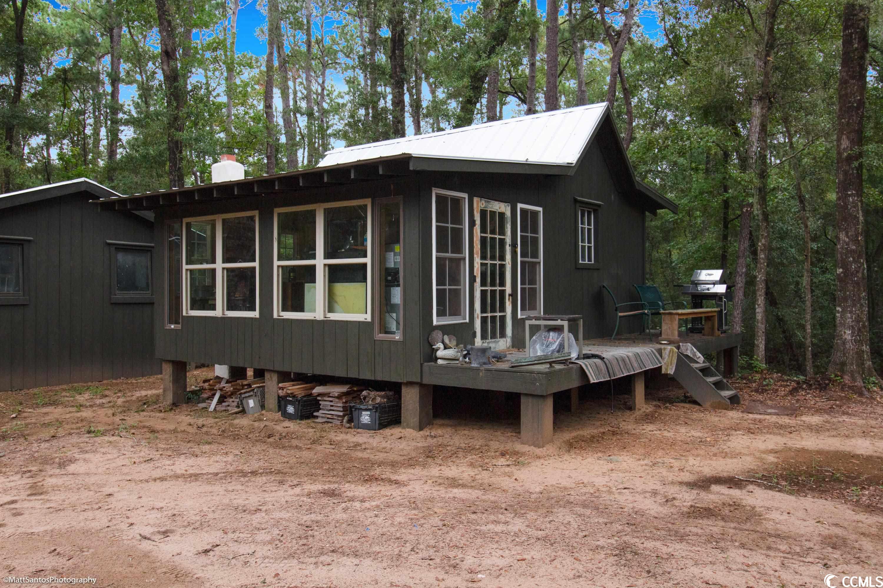 total acreage: approximately 8.53 acres, with approximately 2.25 acres upland.  new cabin and barn built last year: a new cabin and barn were built on the property last year, providing comfortable accommodations for guests.  fish camp overlooking old richfields: the fish camp overlooks the old ricefields, offering stunning views and plenty of opportunities for fishing and other outdoor recreation.  multiple barns and structures on property: there are multiple barns and other structures on the property, which could be used for a variety of purposes, such as storage, workshops, or additional guest accommodations.  950 feet to the river: the property has 275 feet of frontage on the north santee river, providing easy access to fishing, boating, and other watersports.  70' of dock on deep water: there is a 70-foot dock on deep water, making it ideal for launching boats and fishing from the dock.  sportsman's paradise: the property is located in a prime hunting and fishing area, with abundant opportunities for deer, turkey, waterfowl, and other game.  location: the property is located within 30 minutes of charleston and 20 minutes of georgetown, making it a convenient getaway for residents of both cities.  overall, this property is a great opportunity for anyone looking to own a fish camp in a beautiful and secluded setting. the property has plenty of amenities to offer, including a new cabin and barn, multiple barns and structures, 950 feet of river frontage, a 70-foot dock on deep water, and a convenient location. this property is perfect for anyone who loves to fish, hunt, boat, or simply enjoy the outdoors.