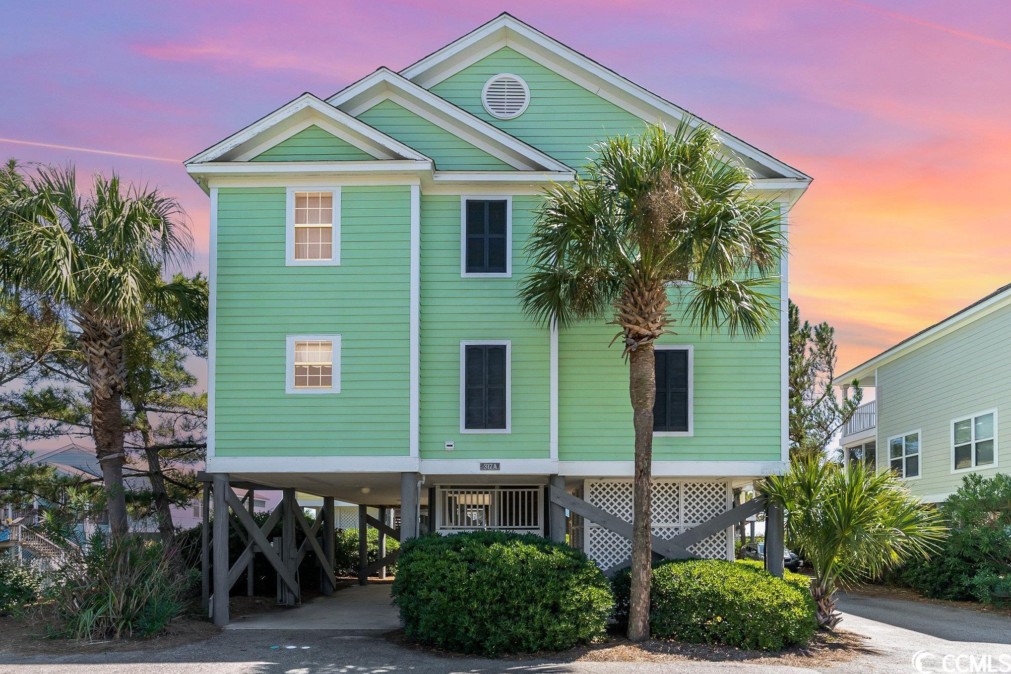 experience coastal living at its finest in this stunning 4 bedroom, 3 bath home nestled on the ocean side of waccamaw blvd. located just steps away from the pristine beach, you'll never have to cross the street to dip your toes in the sand.  this home boasts upgrades galore, with luxurious lvp flooring throughout. it comes fully furnished, making it the perfect turnkey vacation or investment property with huge rental history. take advantage of the community pool for a refreshing dip after a day at the beach and enjoy easy public access to the shore.  situated in a cozy community of only 10 homes, you'll relish the tranquility and privacy this location offers. catch peekaboo views of the ocean from your screened porch and soak in the serene, beautiful ambiance of coastal living.  wake up to breathtaking sunrises over the ocean and savor every moment in this raised beach house that's ready to become your coastal dream retreat. don't miss out on this rare opportunity – schedule your showing today!