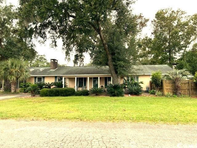 "location, location, location" - this house checks all the boxes!  this generous sized house is tucked away on quiet sassanqua dr across the street from the bay.  enjoy beautiful sunrises and watch the boats go by from your front porch!  if access to school is a priority, maryville elementary is only 3 blocks away.  you can be in downtown georgetown for shopping & dining in 8 minutes and on the beach at pawleys island in 20 minutes.  for boaters, the carroll campbell boat ramp is 5 minutes away.  what more could you ask for?  what about a pool?!  yes, this house has an in-ground pool with a poolside bar and privacy fence!  a sunroom opening out onto the pool area greatly increases your entertaining space for barbeques, cook-outs, etc.  if the weather doesn't cooperate for poolside get-togethers you are fine as the open floor plan inside offers another perfect space for gatherings.  the huge great room with vaulted ceiling & skylights has a large freestanding double-sided wood-burning brick fireplace that gives warmth & ambiance to both the seating & dining areas.  the cook is not excluded from family & guests as only a bar separates the kitchen from both of those areas.  french doors open from the great room/dining/kitchen area into a fenced backyard. a large pantry & laundry room with washer & dryer that convey are just off the kitchen.  an attached side load 2-car garage/driveway is accessible from hill st.   it has plenty of parking for cars, a boat, rv, or golf cart.  another driveway to the property from sassanqua dr offers additional parking.  the house has 3 good size bedrooms, 2 with access to a hall bath & the primary bedroom with its own adjoining bath.  the house has a new hvac and new stainless steel appliances. come quickly to see this great house & all it has to offer!!