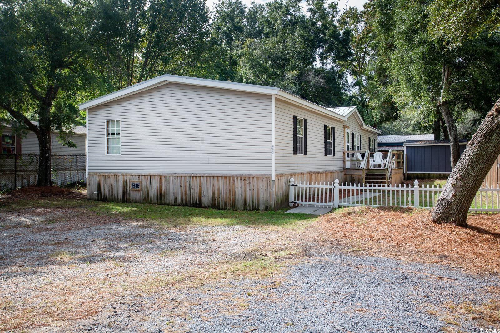 location, location, location. this double wide boasts 4 bedrooms and 2 bathrooms along with an open kitchen/living area with a fireplace. the lot is privacy fenced on 3 sides. new metal roof in 2023. no hoa. storage shed conveys. located toward the south end of murrells inlet, it is a short walk to several restaurants. it's only 1.5 miles to the world famous marshwalk of murrells inlet. this home won't last long.