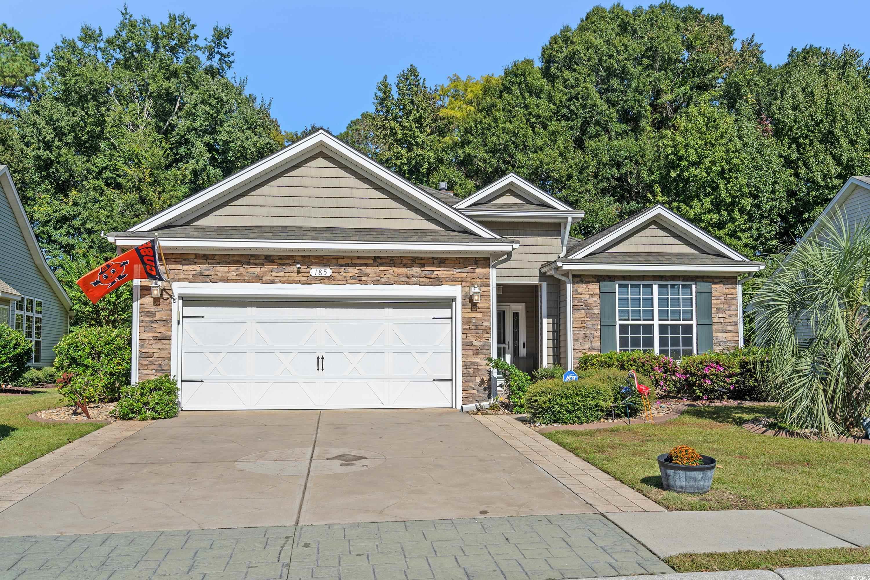 welcome to myrtle trace grande, a picturesque 55+ community that is perfectly tailored to meet the needs and desires of the discerning buyer. this immaculate home offers a harmonious blend of modern comfort, stylish design, and ageless elegance. upon arrival, the charming curb appeal of this property sets the tone for what lies inside. an extended stamped driveway with decorative etching and meticulously maintained landscaping adorned with riverstone and curbscaping create a warm and inviting atmosphere. stacked stone accents on the front of the home add a touch of sophistication, and a welcoming sidewalk encourages you to explore this vibrant community at your leisure. as you step inside this splendid residence, you're greeted by a spacious, open, and functional floorplan boasting a beautiful neutral color theme that sets the stage for personalized decor. the living room area is a cozy haven, featuring a propane fireplace, a ceiling fan, hickory wood flooring, and crown molding, all combining to create an inviting ambiance ideal for relaxation and social gatherings. the large eat-in kitchen is a chef's dream, offering tile flooring, stainless steel appliances, including an induction stove for precision cooking, quartz countertops, expansive cabinetry equipped with convenient slide-outs, a stylish backsplash, a pantry for storage, and privacy film on the windows for privacy. the pendant lights and chandelier in the breakfast nook are thoughtfully equipped with dimmer switches to tailor the lighting to your preferences. the master suite boasts a tray ceiling, a ceiling fan for climate control, a walk-in closet for your wardrobe, and a private bathroom that feels like a spa retreat. the master bathroom is a true highlight, featuring a large walk-in custom tile shower with several niches and a seat, dual sinks, and a transom window that bathes the space in natural light. the other two bedrooms and a full bathroom are thoughtfully situated toward the front of the home, providing separation and privacy when needed. each of these bedrooms is generously sized and enhanced with ceiling fans for added comfort. one of the standout features of this home is the delightful 10x20 sunroom located just off the living room. this versatile space is an ideal sanctuary for relaxation or entertaining guests, offering endless possibilities to make it your own. the laundry room comes complete with a stackable washer and dryer, a utility sink, and provides convenient access to the garage, which is equipped with a screen, allowing you to enjoy a pleasant breeze while working on projects or hobbies. step outside into the fenced backyard, and you'll discover a tranquil oasis with a patio that provides ample space for seating and grilling. enjoy beautiful views of the surrounding trees and shrubs, creating a serene backdrop for your outdoor moments. this home is not only beautifully appointed but also equipped with thoughtful upgrades, including gutters with a helmet system for easy maintenance, an irrigation system for a lush lawn, pavers and fencing around the trash and propane tank areas, and a new water heater for your peace of mind. myrtle trace grande offers a fulfilling lifestyle with amenities and the convenience of the perfect location. residents here enjoy a community pool and hot tub. there are many organized activities so you can be as busy or as laid back as you desire. your address, conveniently located between conway and the atlantic ocean, granting you close proximity to all the attractions and amenities of myrtle beach, including fine dining, world-class entertainment, ample shopping experiences along the grand strand, and conway’s antique shops, local eateries, and the river walk. rest easy knowing you are only a short drive from medical centers, doctors’ offices, pharmacies, banks, post offices, and grocery stores. all information has been provided to the best of our ability and should be verified by buyer.