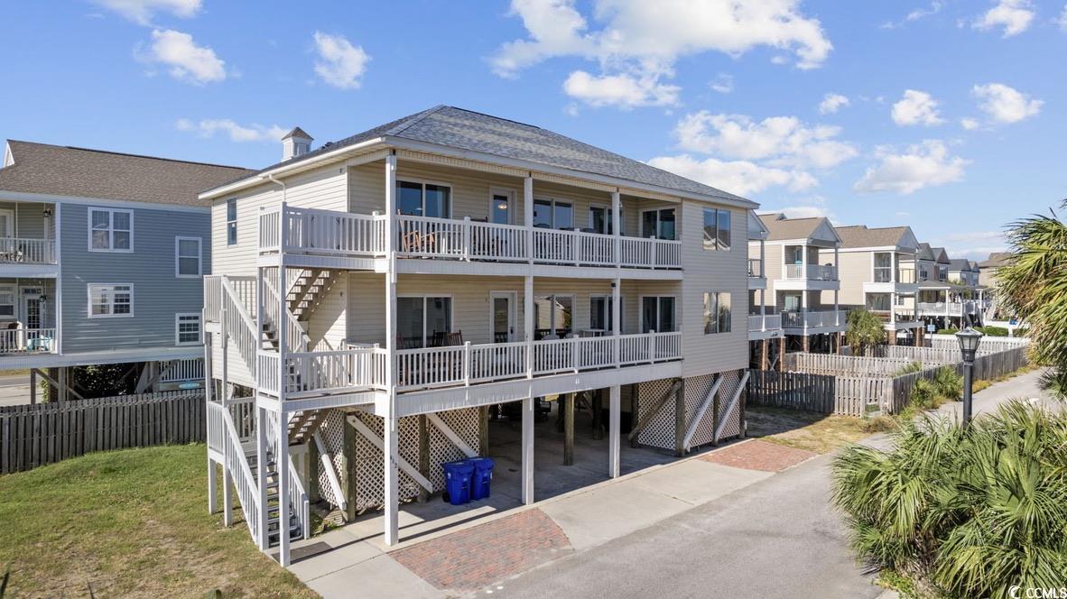 absolutely breathtaking ocean views await you from multiple angels in this remarkable multi-unit property located in surfside beach. each unit features four spacious bedrooms and two well-appointed bathrooms, offering plenty of room for you and your guests. wake up with the view of the sunrise and to the soothing sound of waves crashing on the shore. enjoy the stunning ocean views from  most of the bedrooms, kitchens, living rooms, and the huge front porches, perfect for sipping your morning coffee or unwinding with a glass of wine in the evening. with a modern touch, this property boasts solid flooring, granite countertops, and smooth ceilings throughout both units, ensuring a sleek and low-maintenance living. don't miss out on this exceptional chance for investment.this duplex can be used as one property or as separate units with separate kitchens and entrances. this house can sleep 28 people comfortably. with no hoa and incredible rental history, this special 2 in 1 exceptional property won't be on the market for long. contact us today to schedule a showing and make this your dream oasis.